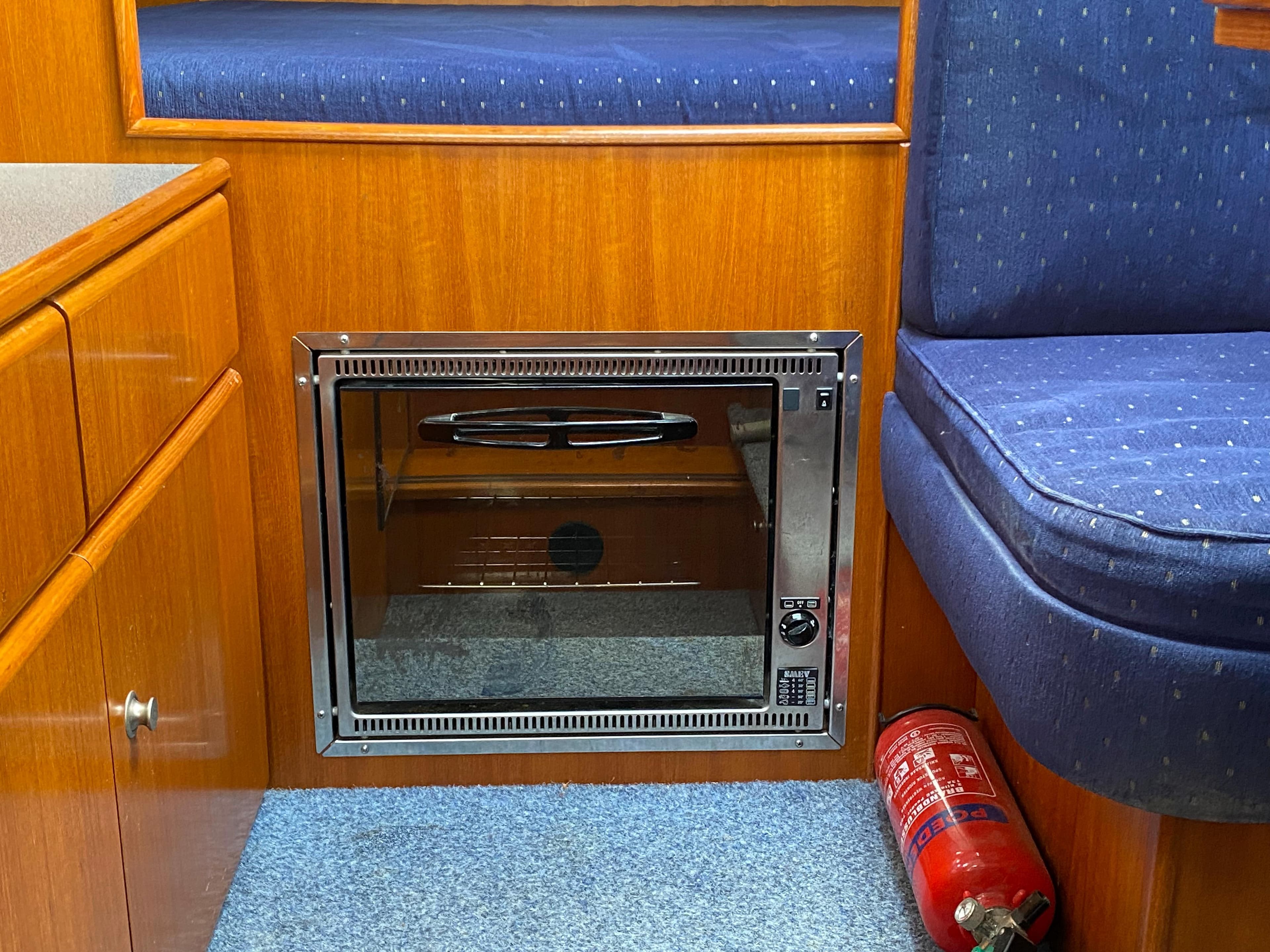 Interior of 2007 Pedro Marin 30 boat with built-in oven and fire extinguisher.