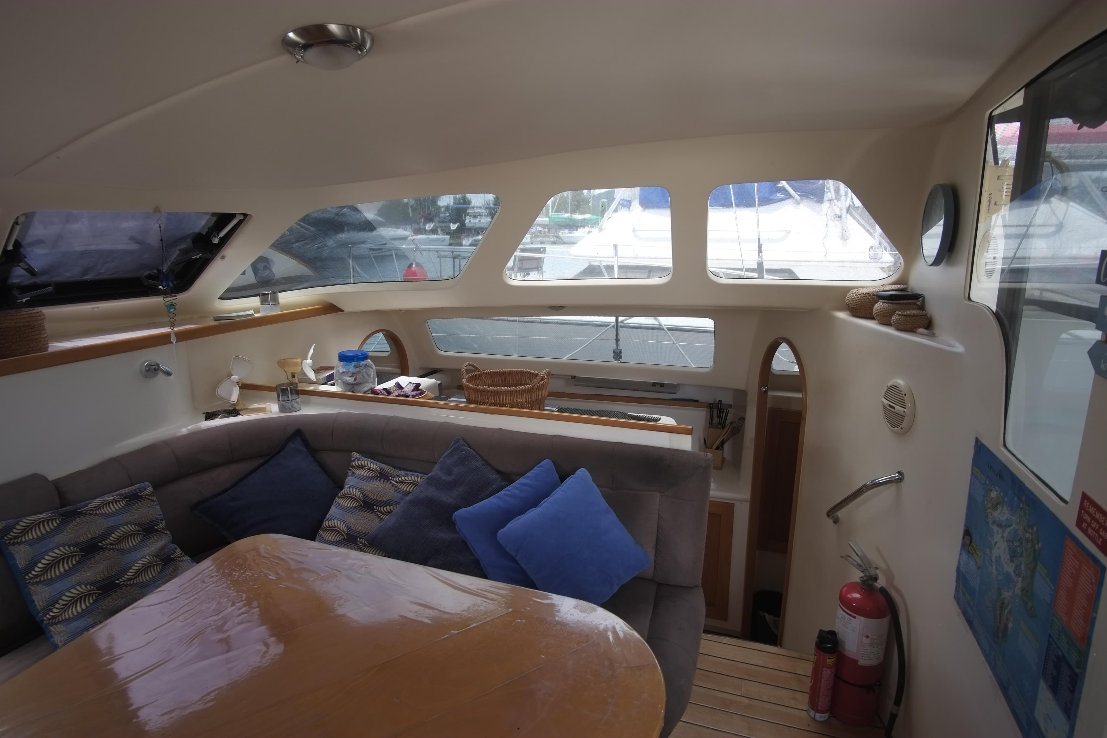 Interior of 2007 Lightwave 38 yacht with cozy seating and wooden table.