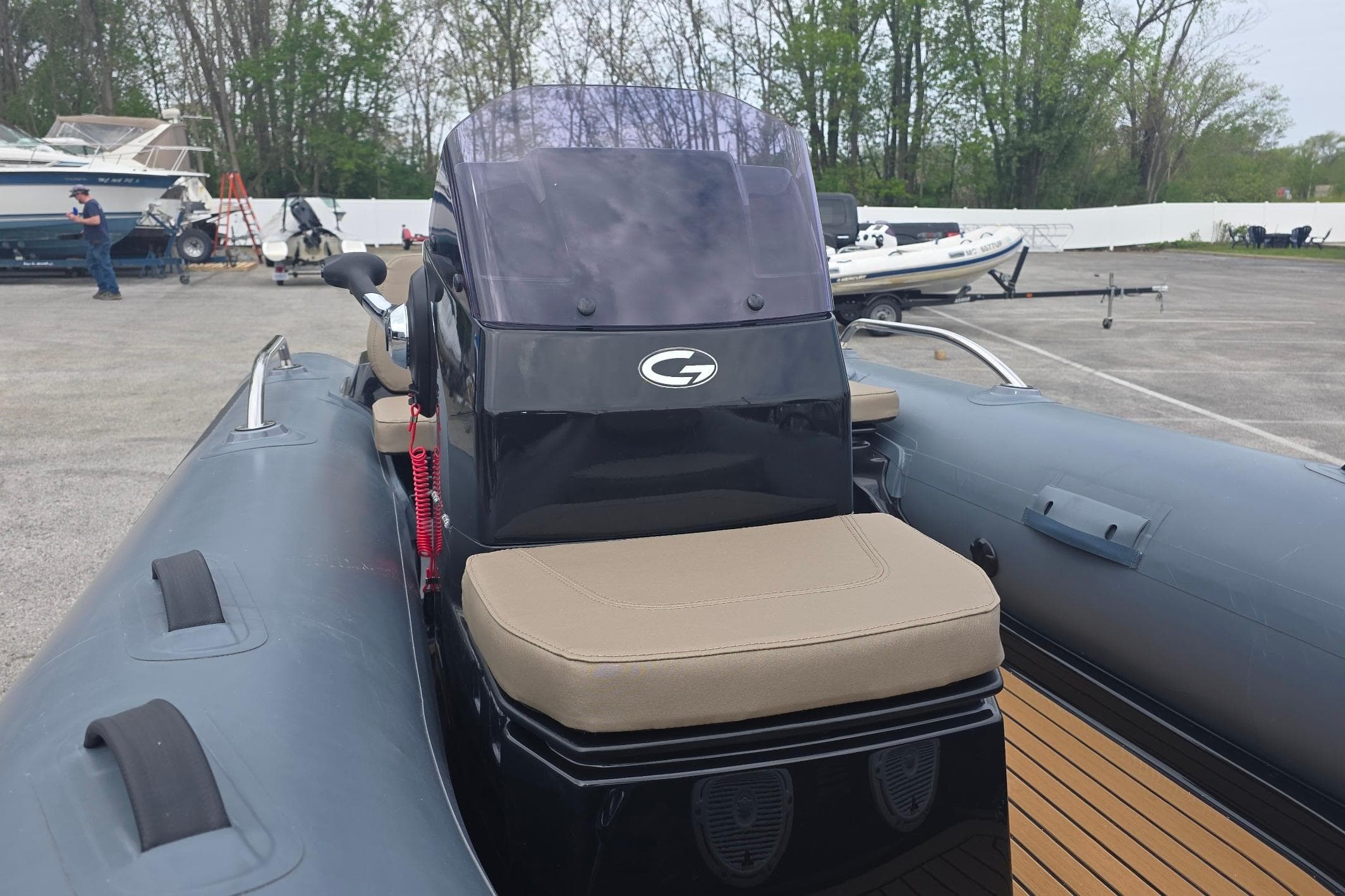 2027 Grand Inflatables G380N boat with sleek design and comfortable seating in a marina setting.