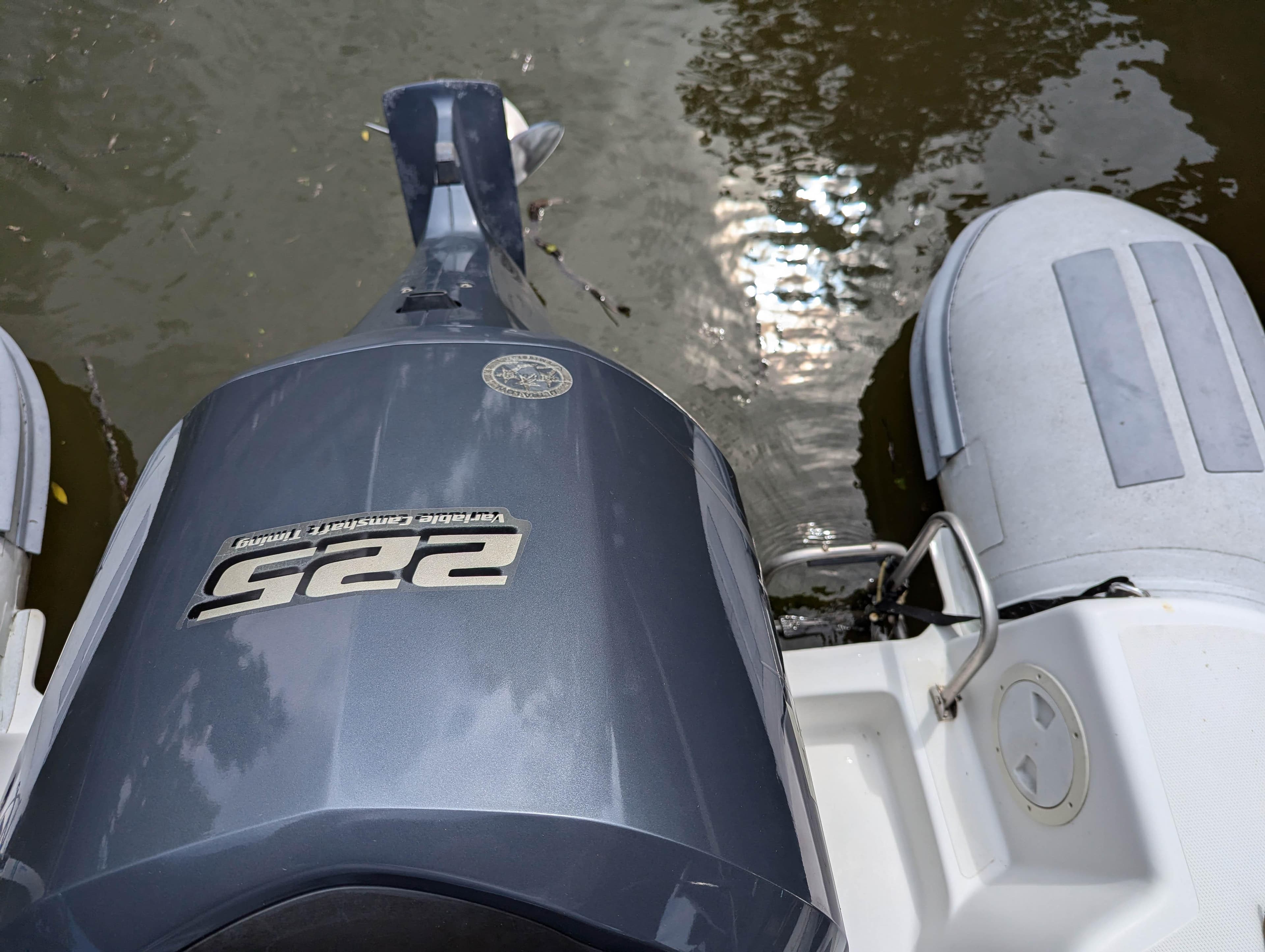 Caribe UB 24SC 2011 boat with outboard motor on water.