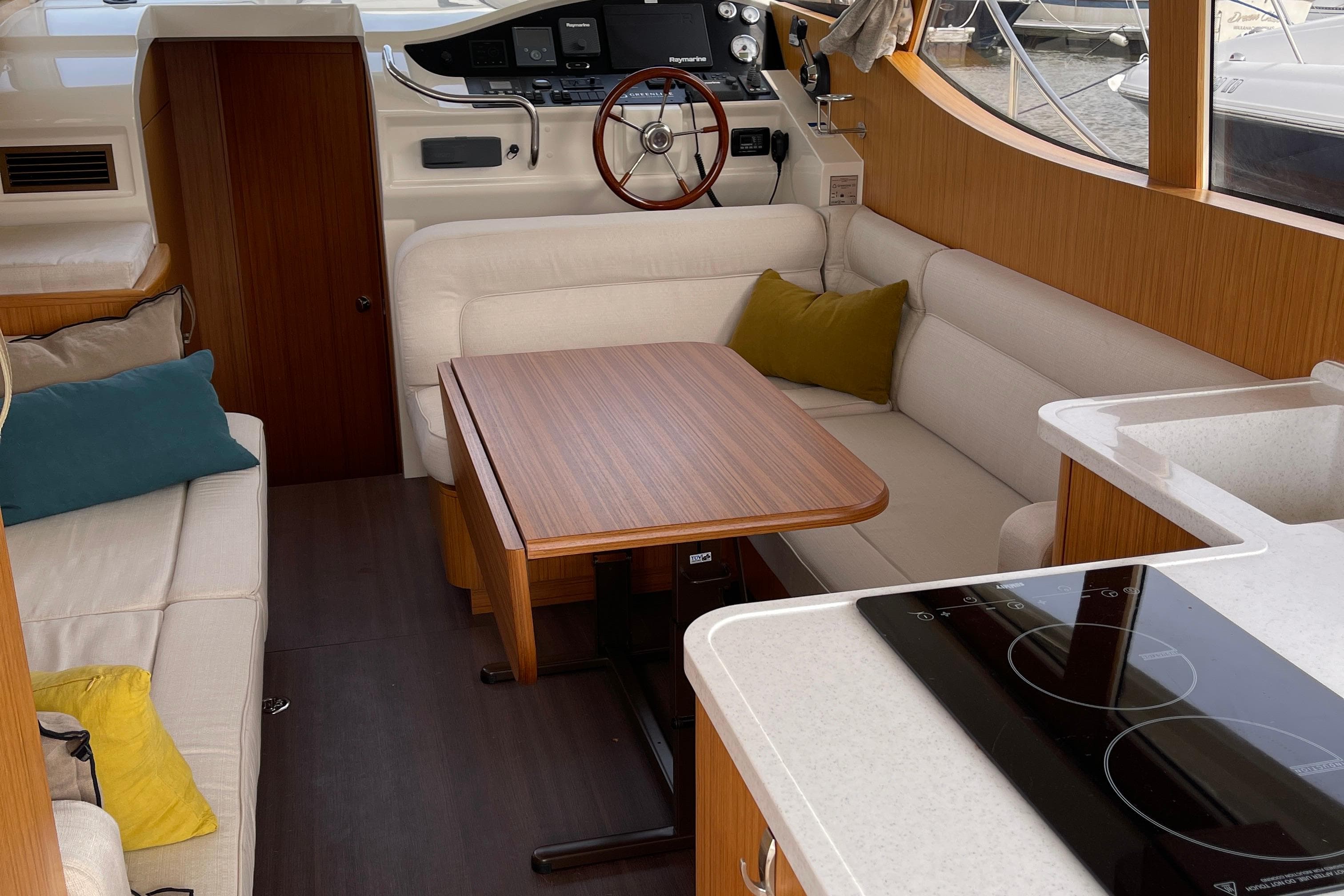 Interior of 2019 Greenline 33 Hybrid yacht with modern seating and kitchen area.