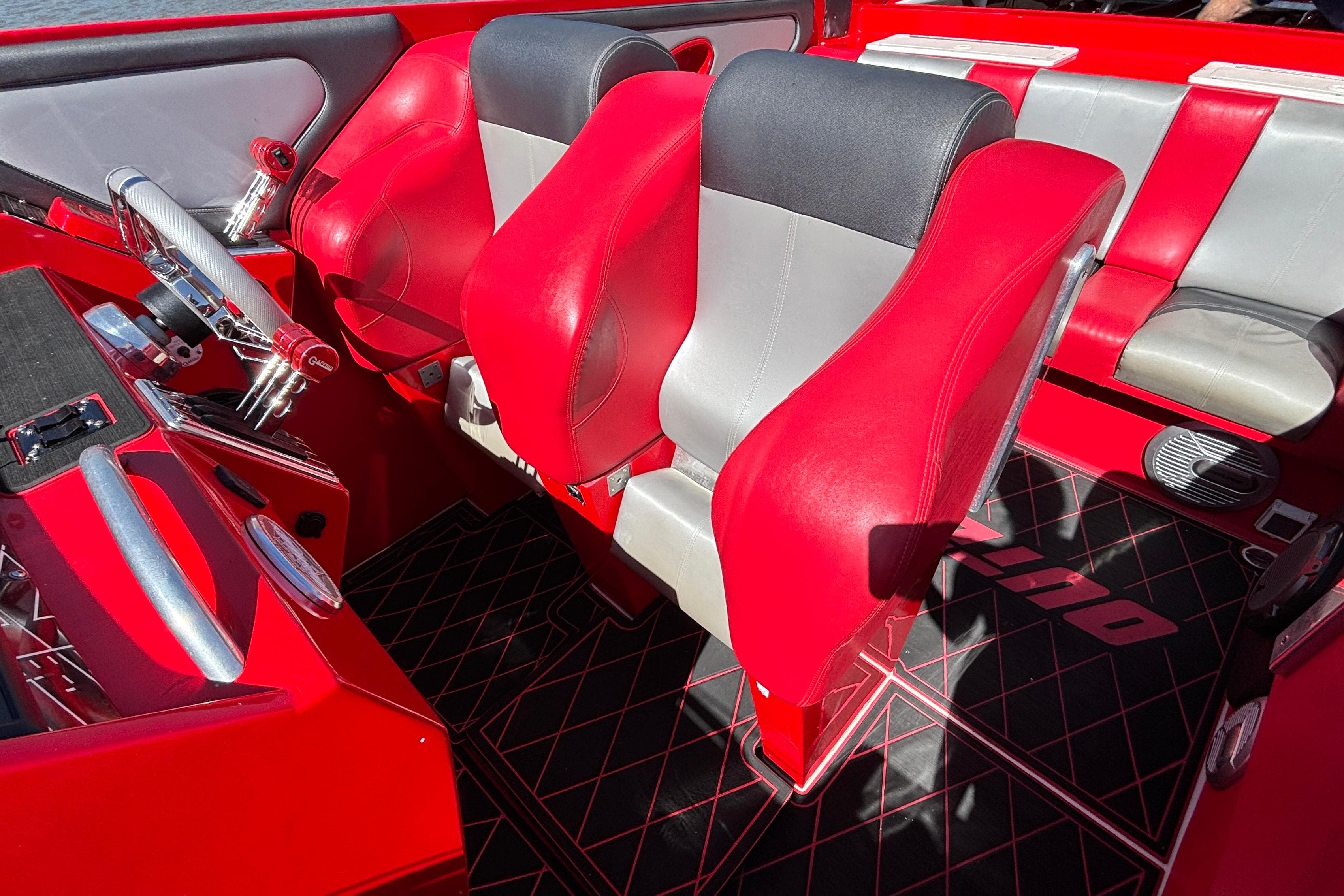 Interior of a 2004 Outerlimits 42 Legacy boat with red and gray seating.