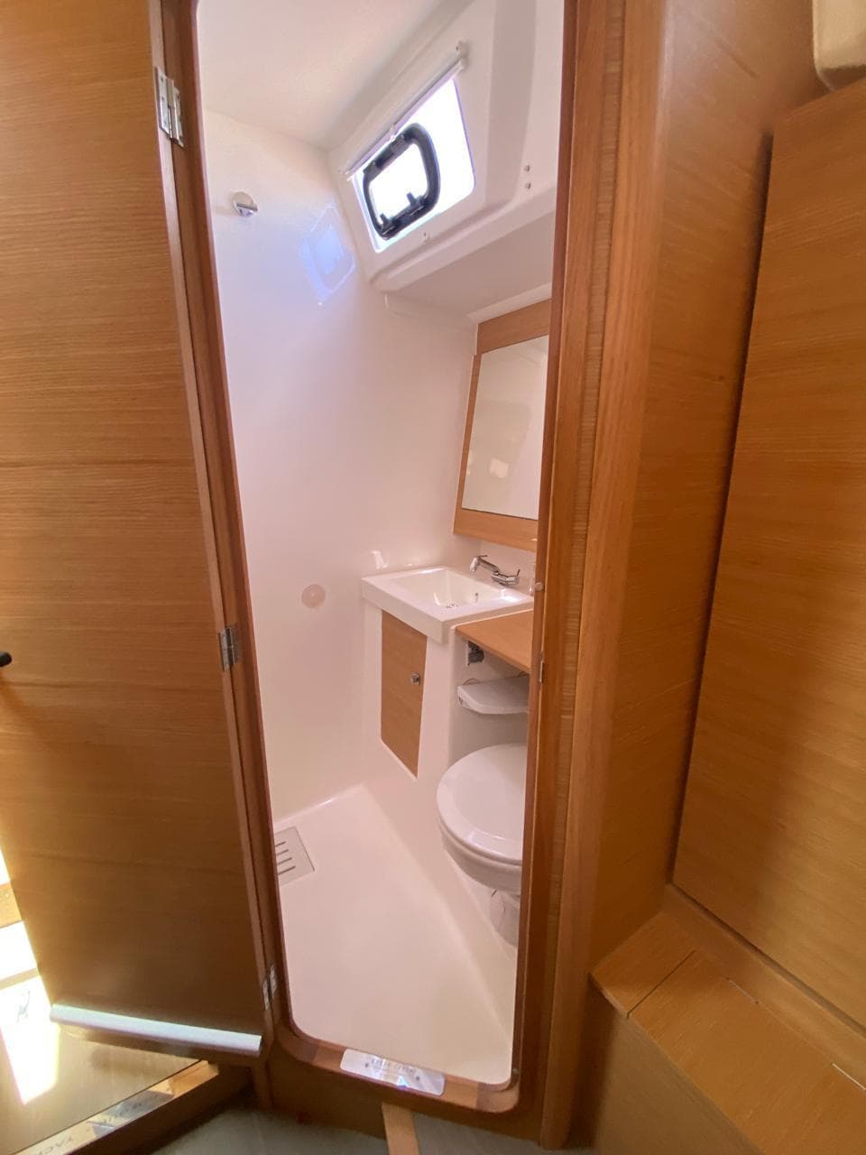 2017 Dufour Exclusive 56 yacht bathroom with wooden accents and modern fixtures.