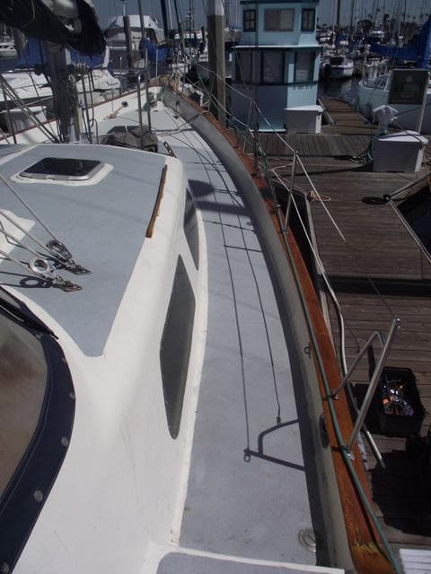 1984 Irwin Center Cockpit sailboat docked at marina, showcasing deck and cabin details.