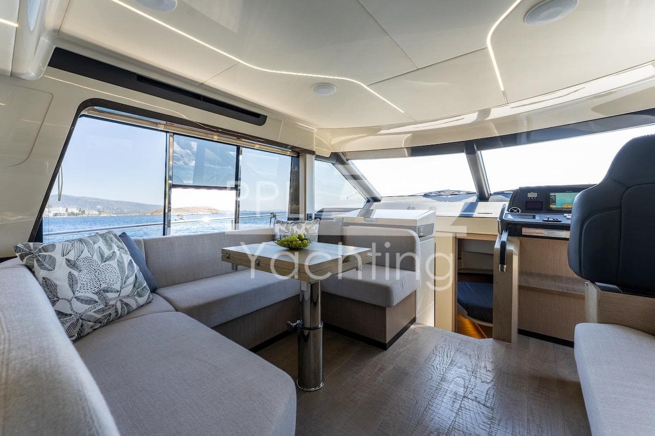 Luxurious interior of 2021 Absolute 47 Fly yacht with modern seating and panoramic windows.
