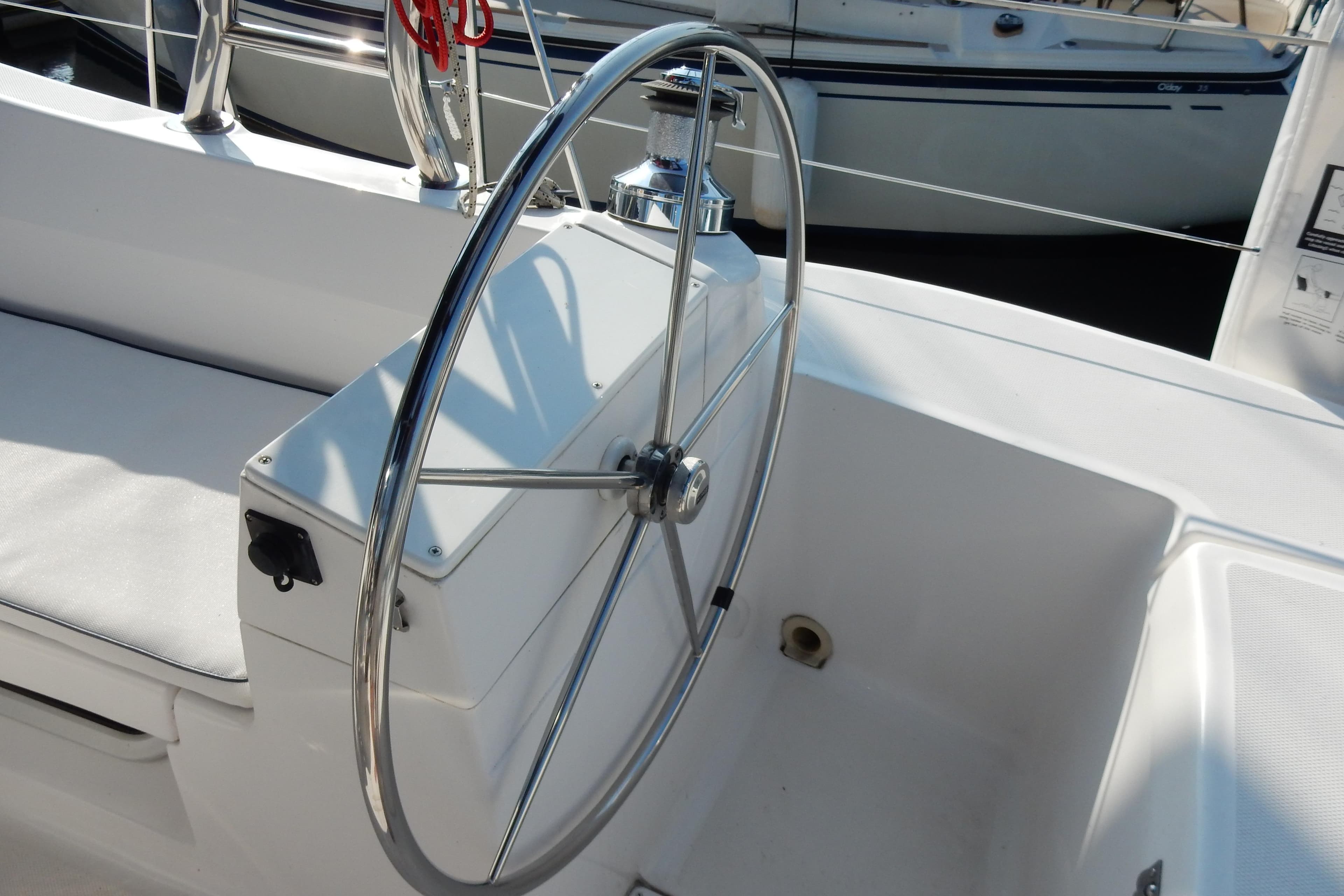Steering wheel of a 2011 Hunter 39 sailboat, featuring a sleek, modern design.