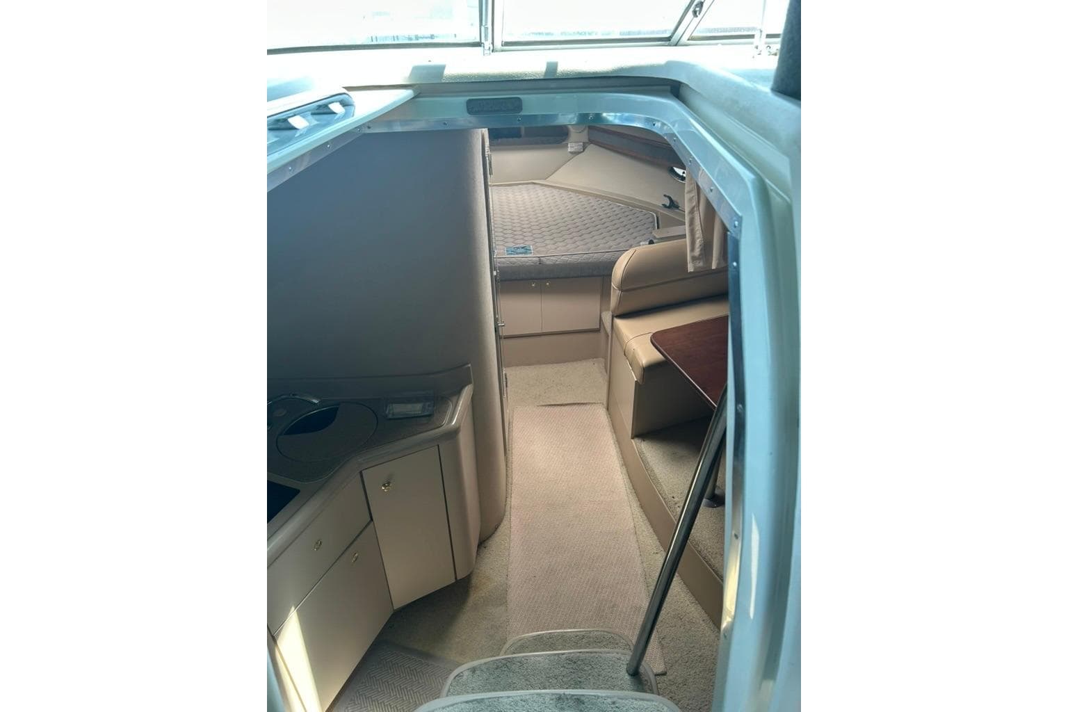 Interior view of 2000 Cruisers Yachts 3575 Express, featuring cozy cabin and seating area.