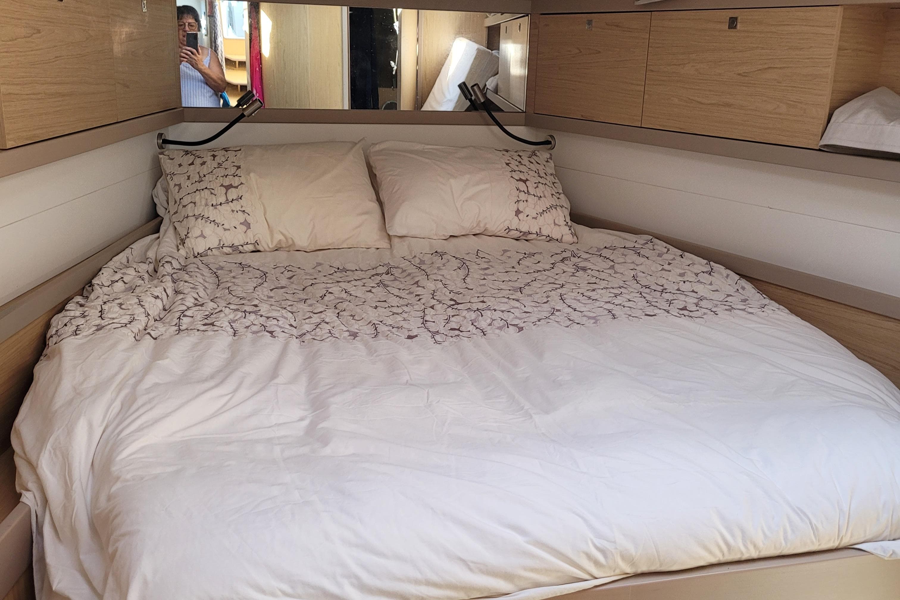 Cozy bedroom interior of 2017 Beneteau Oceanis 45 yacht with plush bedding.