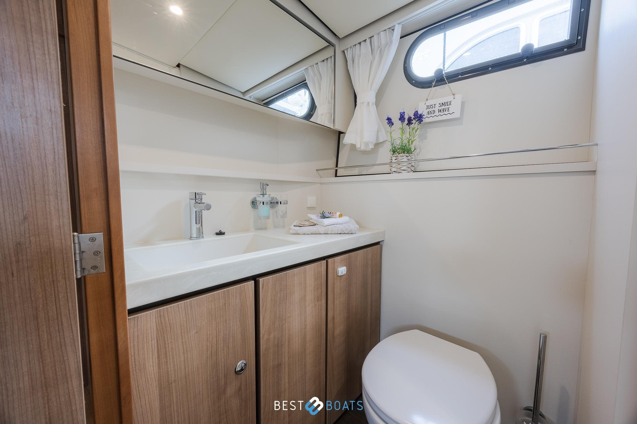 Modern bathroom in 2022 Linssen 40 SL AC yacht, featuring sleek design and wooden cabinetry.