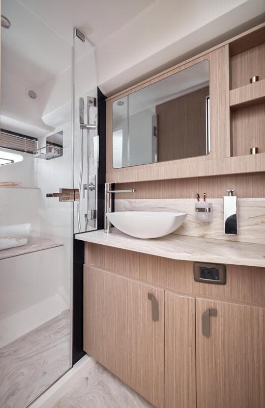 Modern bathroom in 2026 Prestige F5.7 yacht with sleek fixtures and wood accents.