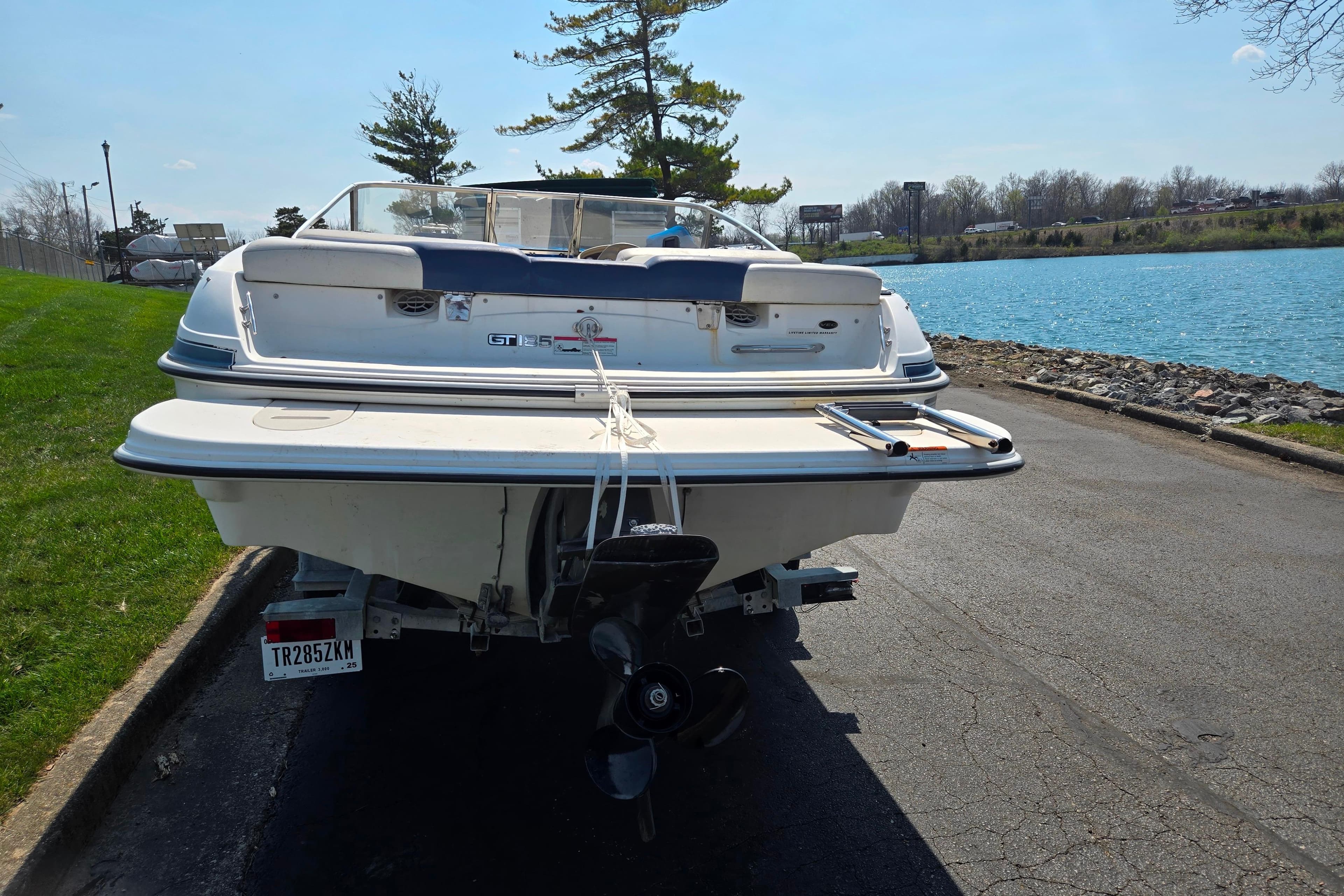 2007 Glastron GT 185 boat parked near a scenic lake.