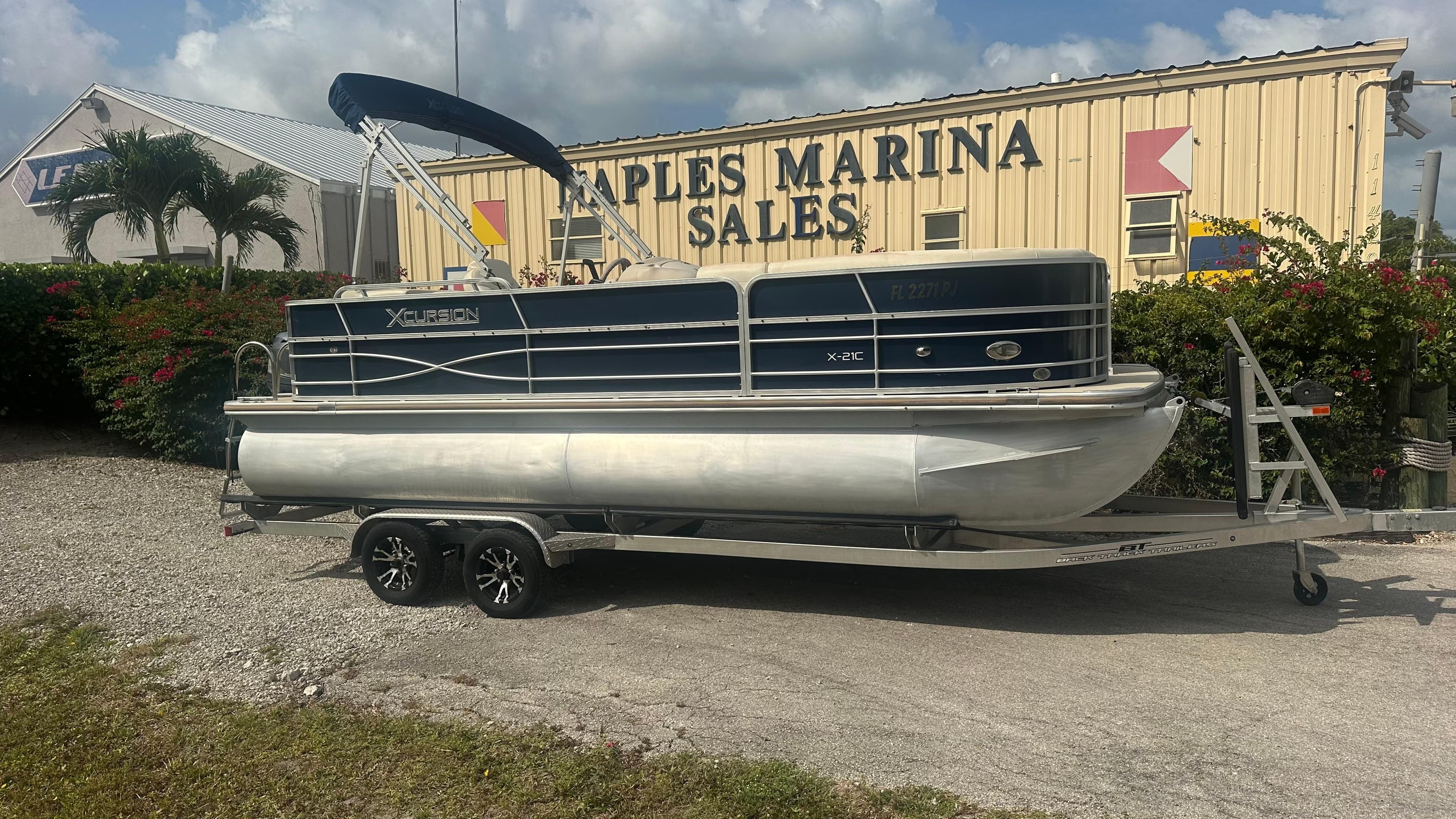 2012 Xcursion X21C pontoon boat on trailer at Naples Marina Sales.