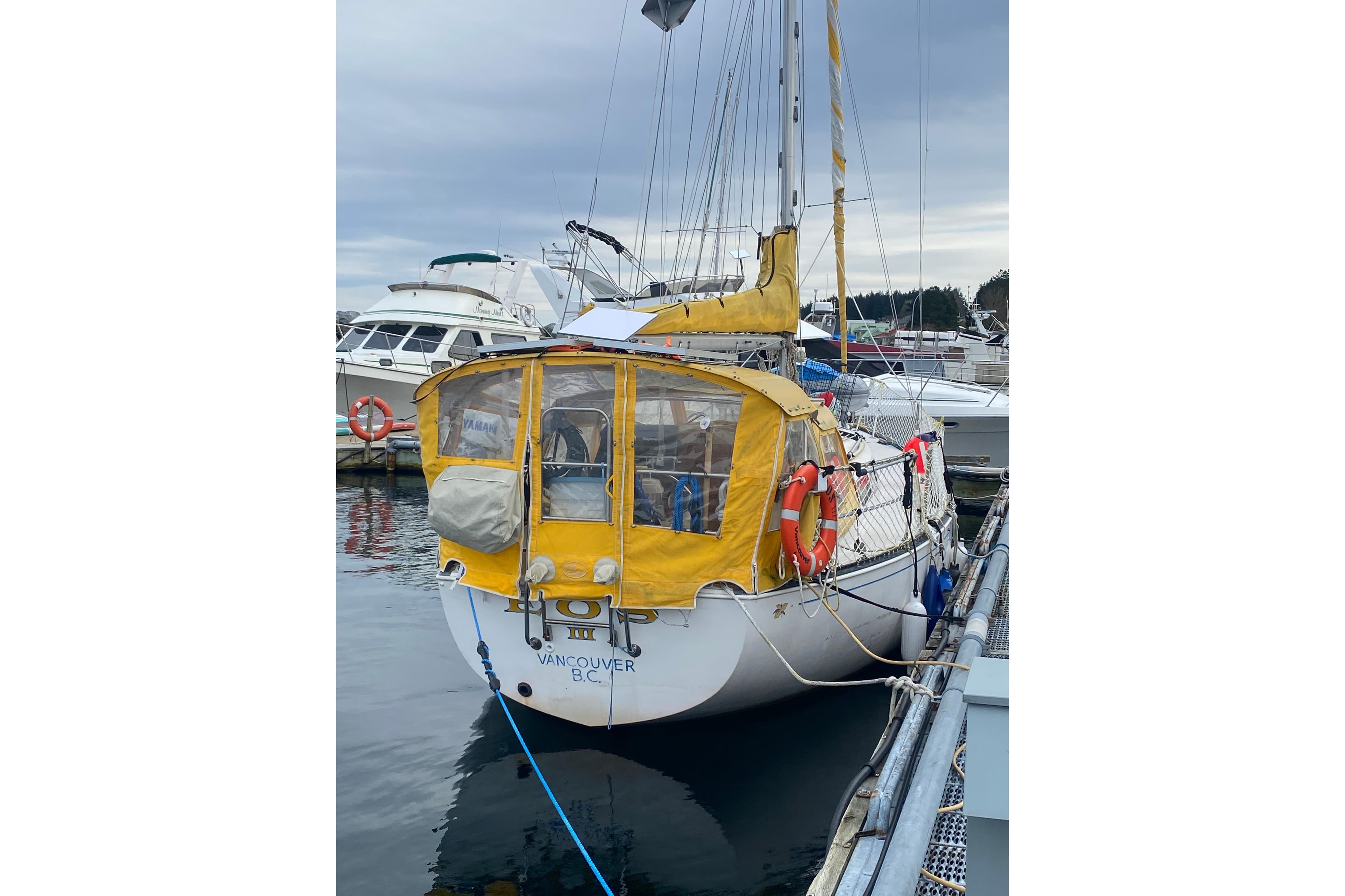1978 Ontario Yachts Ontario 32 sailboat docked in Vancouver marina with yellow canopy.