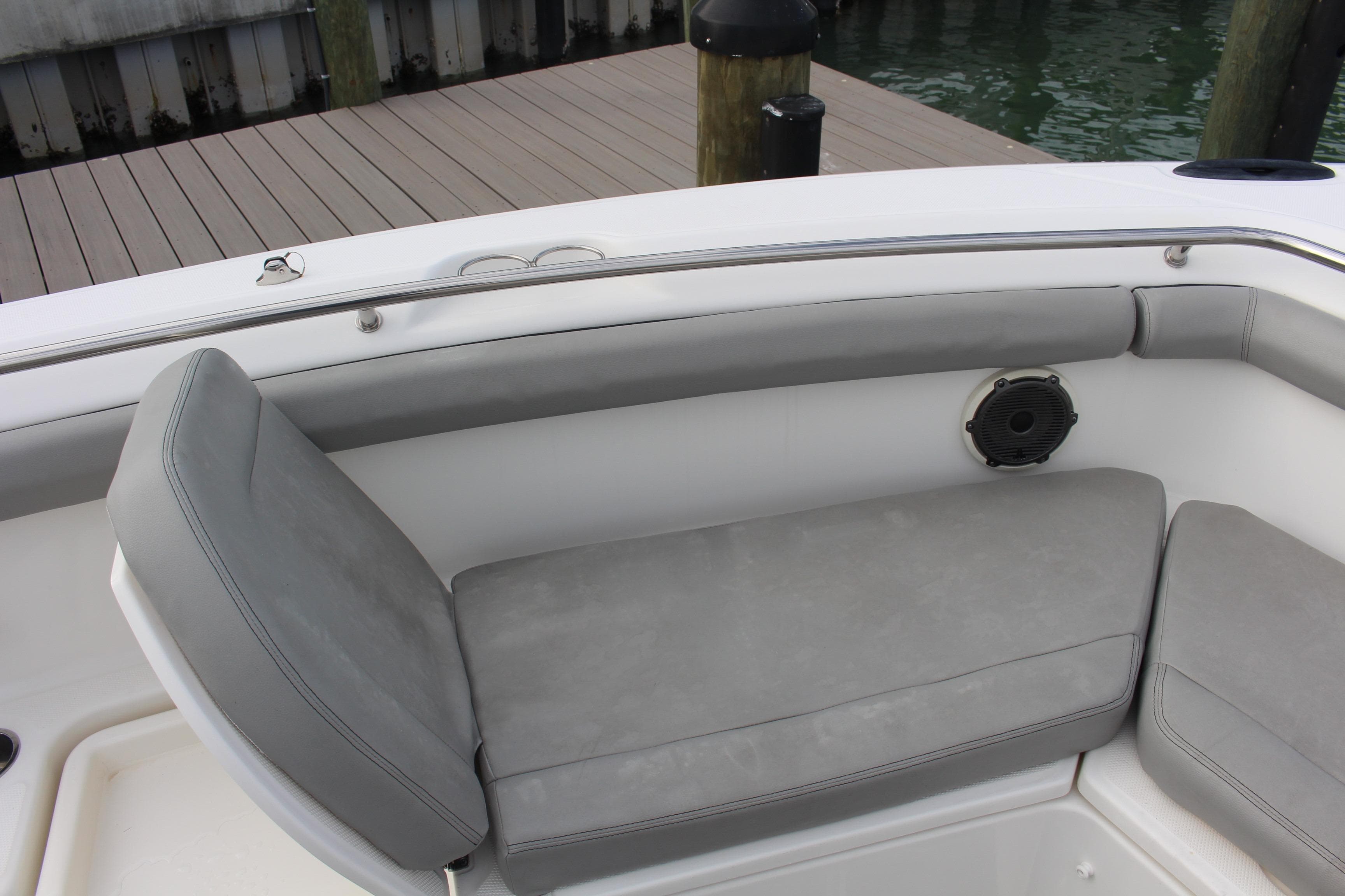 2020 Boston Whaler 350 Outrage boat seating area with gray cushions and speaker.