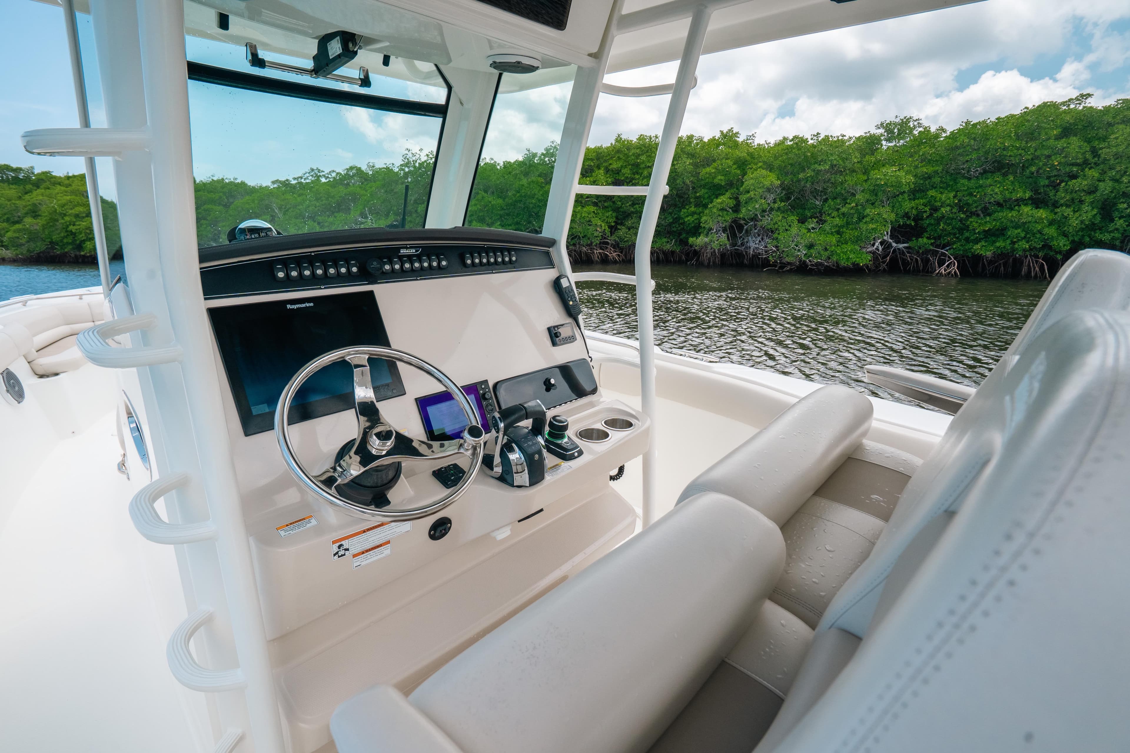 2019 Boston Whaler 330 Outrage boat interior with steering wheel and control panel.