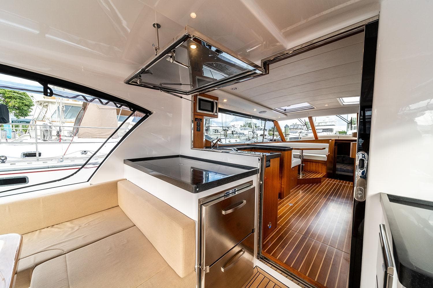 Manufacturer Provided Image: Luxurious interior of 2025 Hylas M49 yacht with modern kitchen and seating area.
