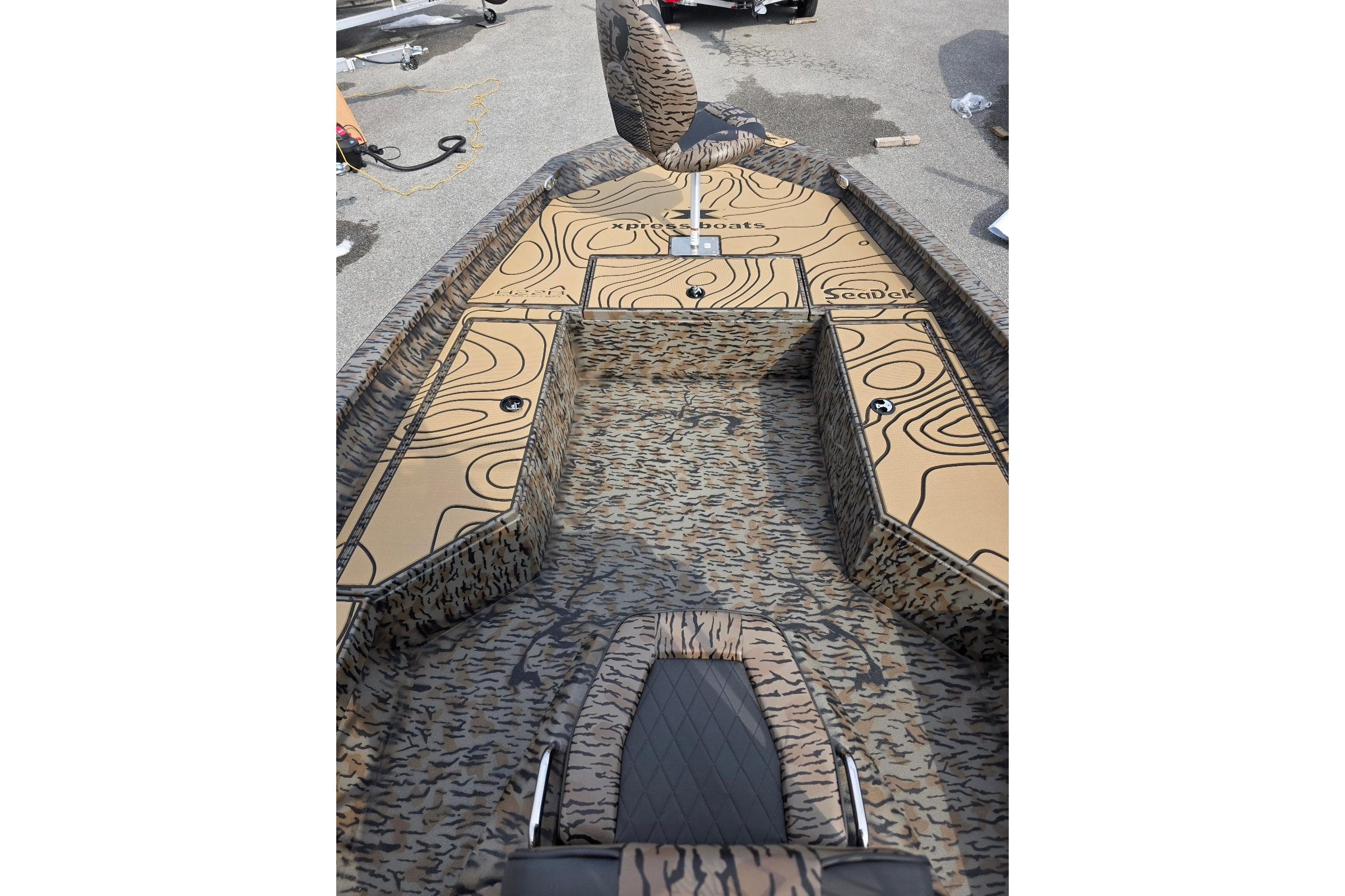 2026 Xpress H22B Bay boat with custom camouflage and topographic design.
