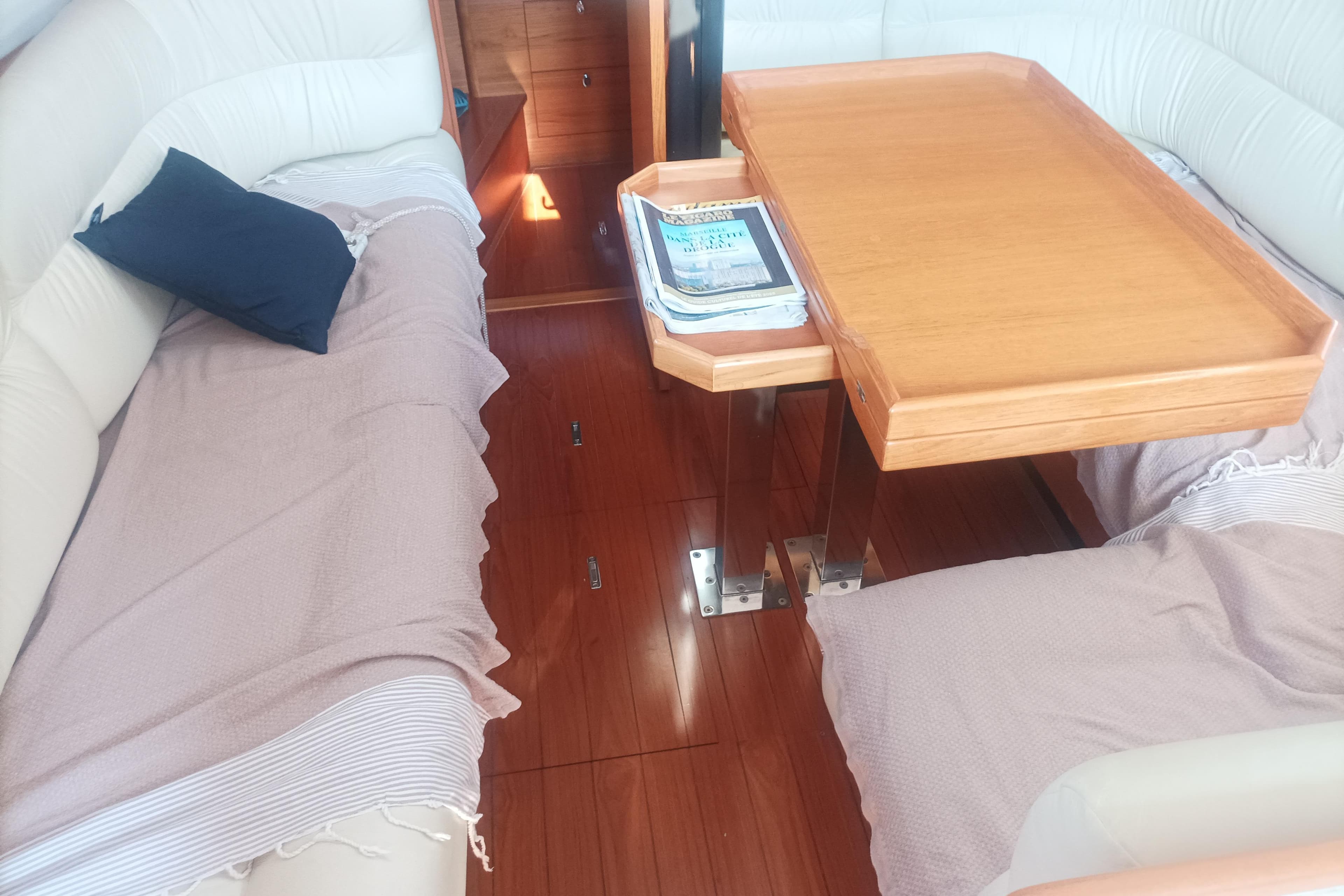 Interior of 2013 Wauquiez Centurion 40S.2 yacht with wooden table and cushioned seating.