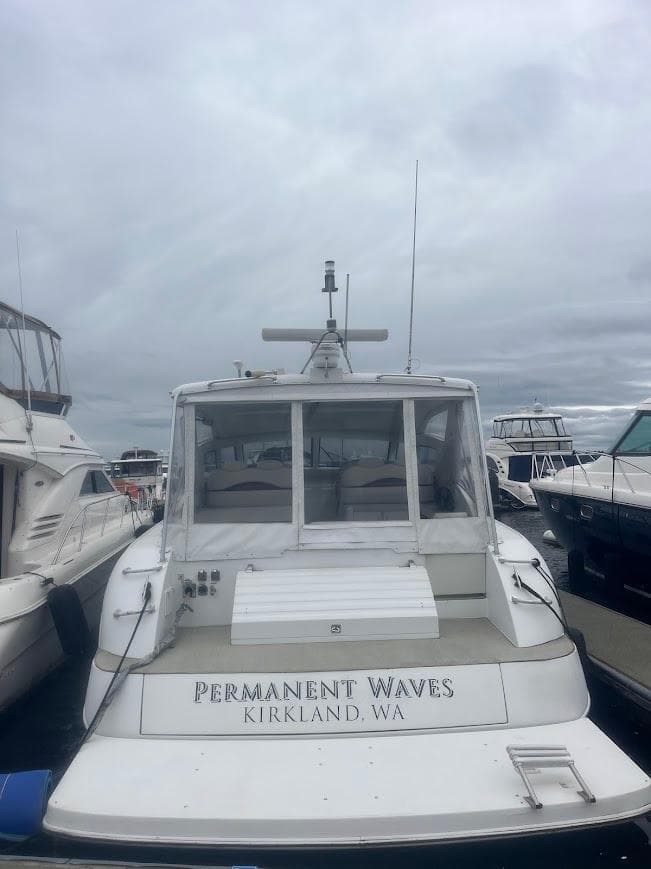 2000 Carver 440 Hardtop Express docked, labeled "Permanent Waves," Kirkland, WA.