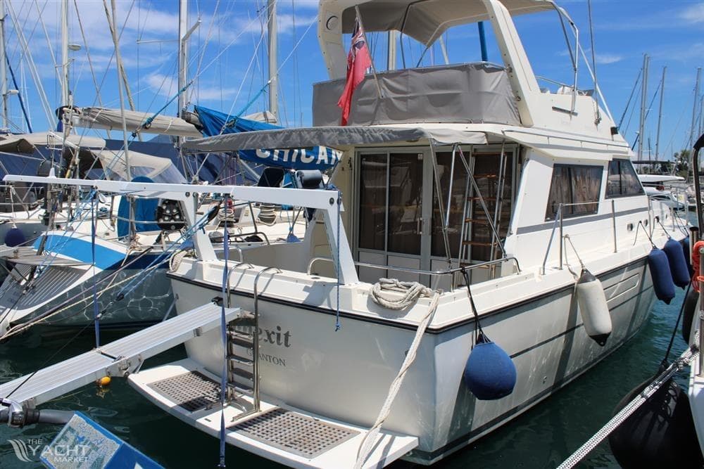 1987 Princess 385 yacht docked in marina, featuring spacious deck and mooring equipment.