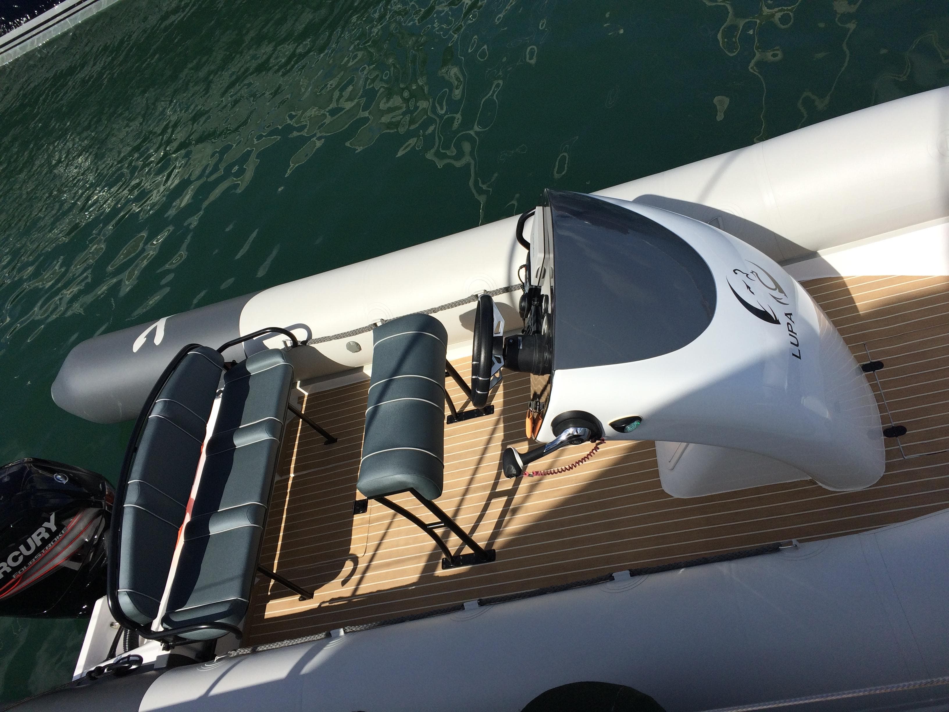 2014 Rib-X XP 590 boat with seating and steering console on water.