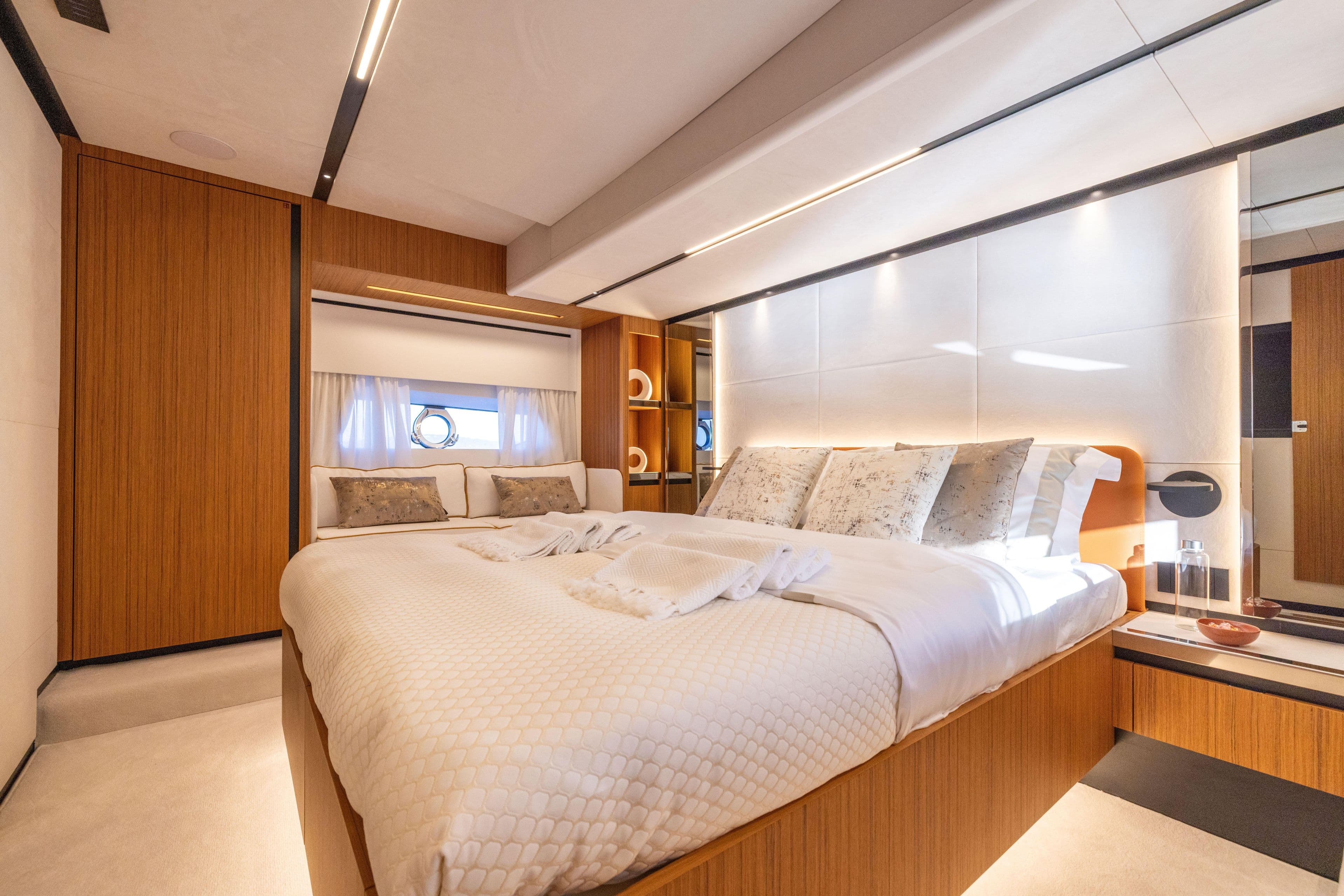 Luxurious bedroom interior of 2025 Solaris Power 60 Open yacht, featuring modern design and cozy bedding.