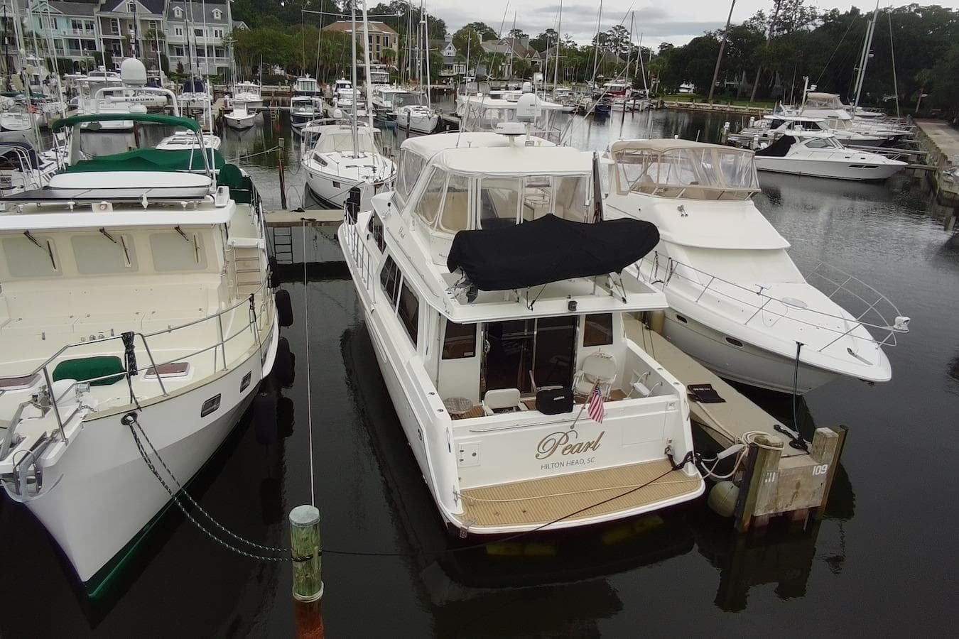 2004 Navigator 4800 yacht docked at marina, surrounded by other boats.