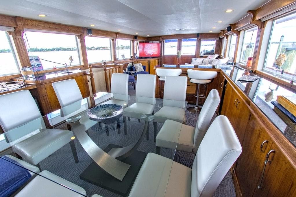 Luxurious interior of 1983 Benetti Custom Lloyds M.Y. yacht with modern dining area.
