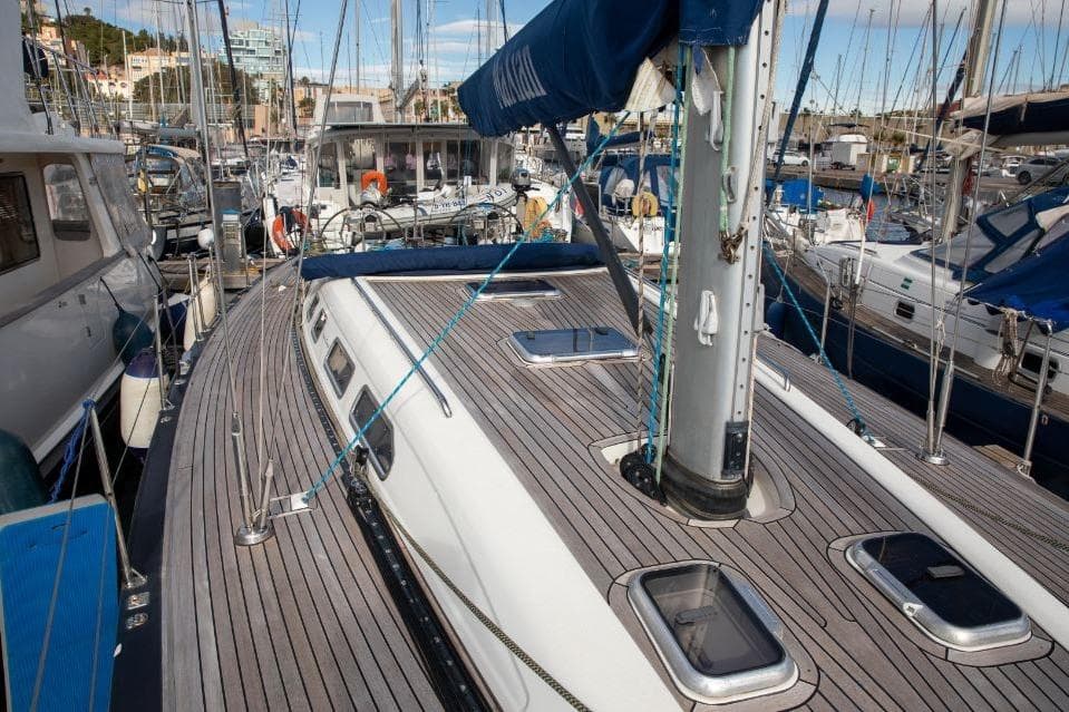 2005 X-Yachts 50 sailboat docked in a marina, showcasing its sleek deck design.