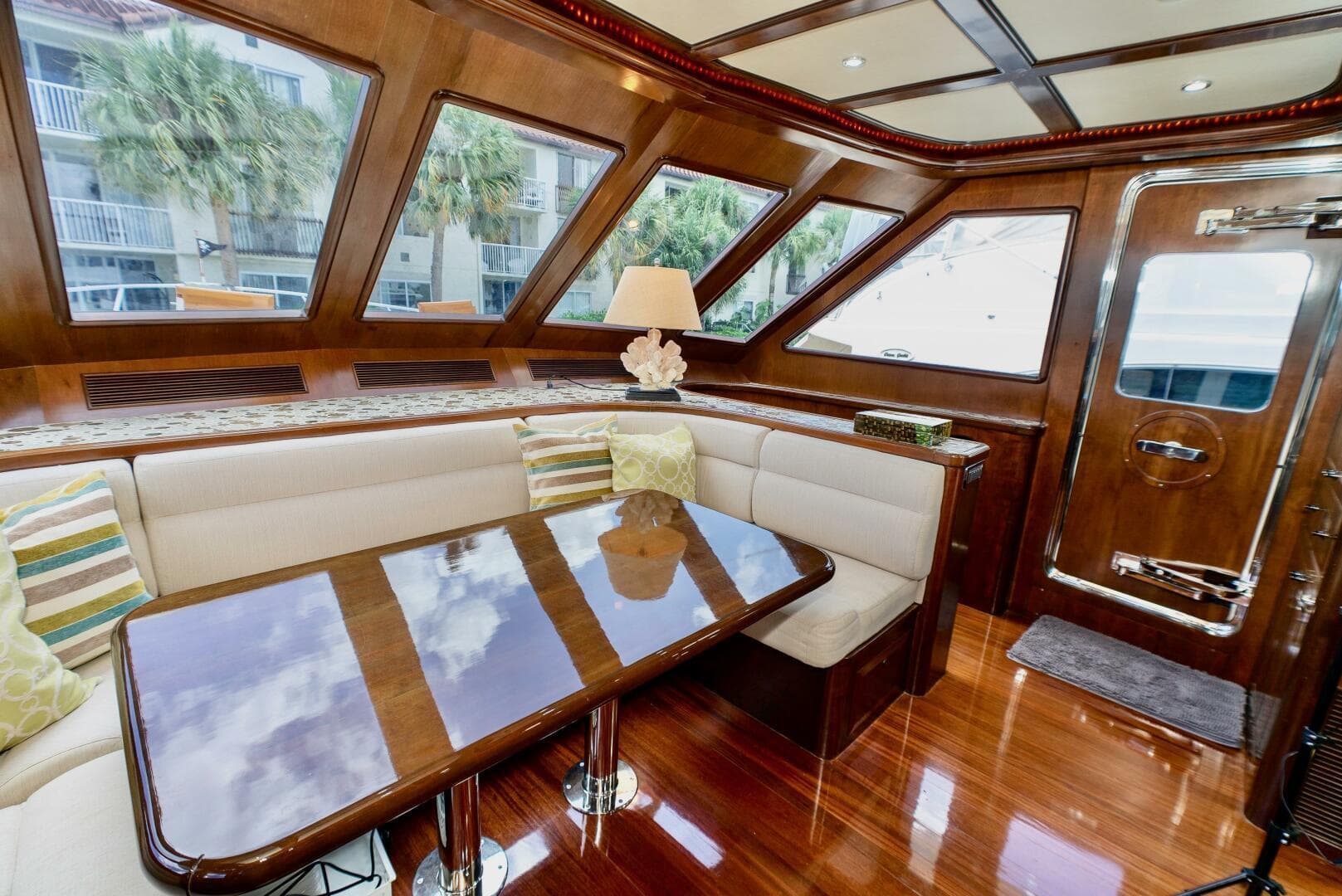 Luxurious interior of 2027 Legend Boats 720 Skylounge with elegant wood finish and plush seating.