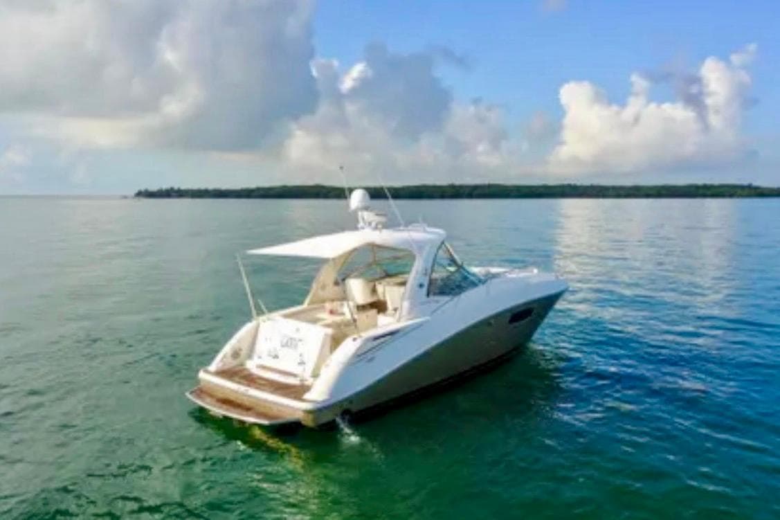2009 Sea Ray Sundancer 350 yacht on calm waters under a blue sky.