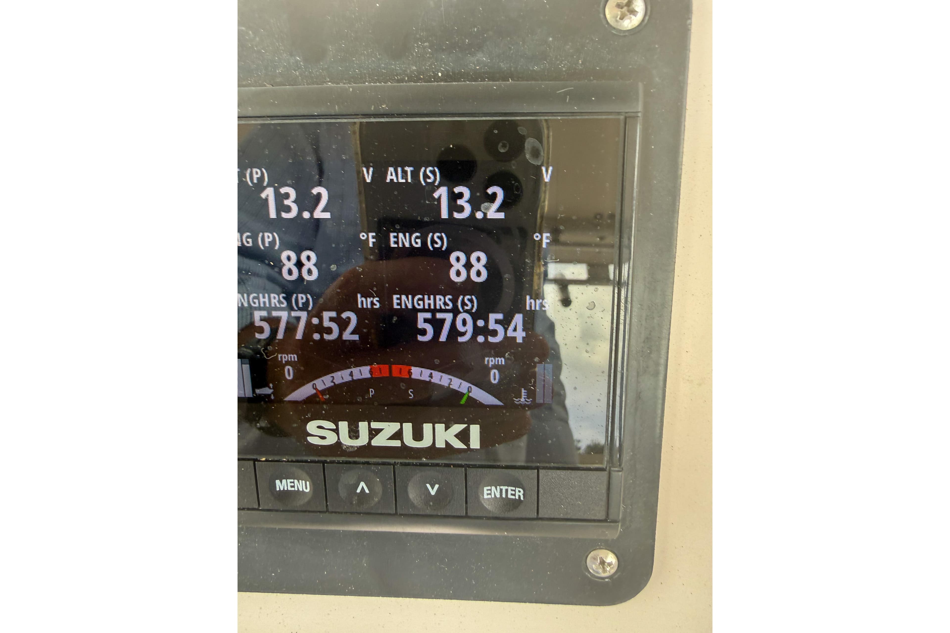 Suzuki engine display on 1997 Grady-White Marlin 300 boat, showing voltage and engine hours.