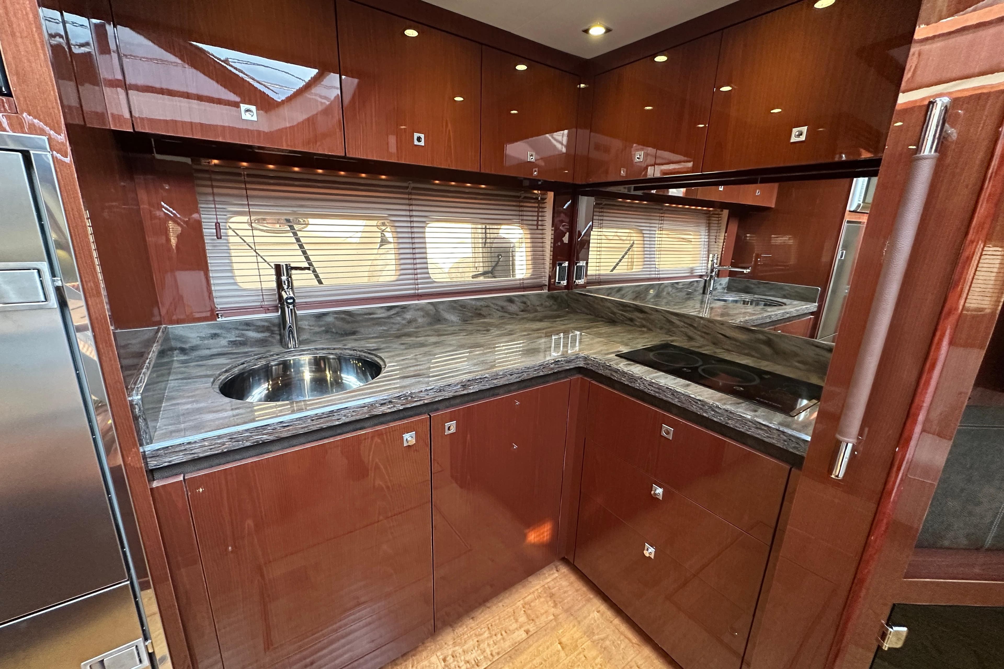 Luxurious kitchen interior of 2014 Sea Ray Sundancer 510 yacht with sleek countertops.