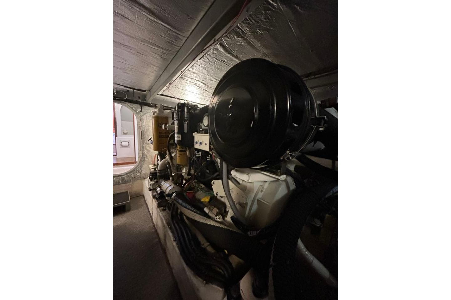 Engine room of a 2005 Hardy Commodore 50 yacht, showcasing mechanical components.