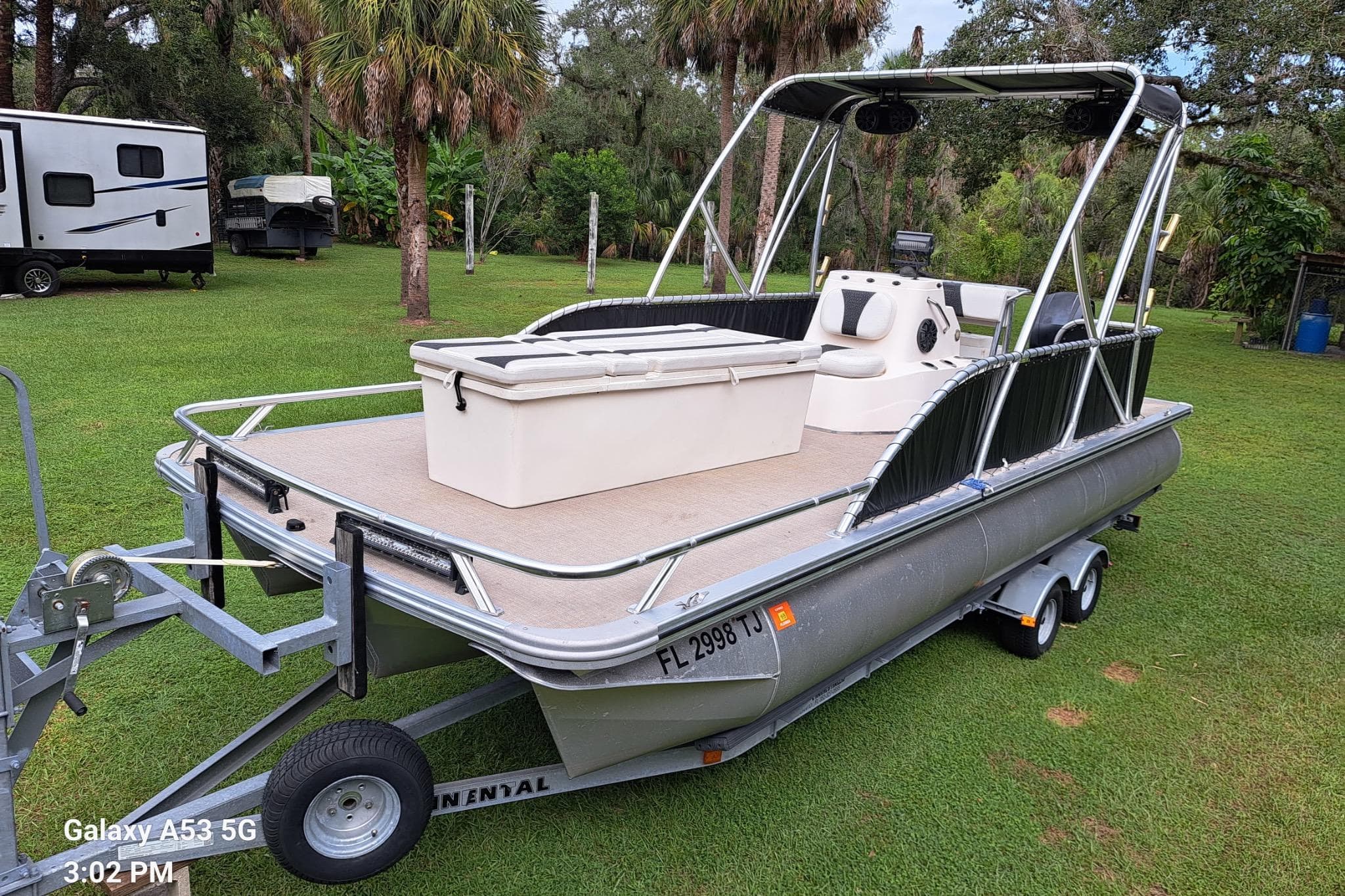 2021 Avalon GS CC Fish 23' pontoon boat on trailer in grassy area.