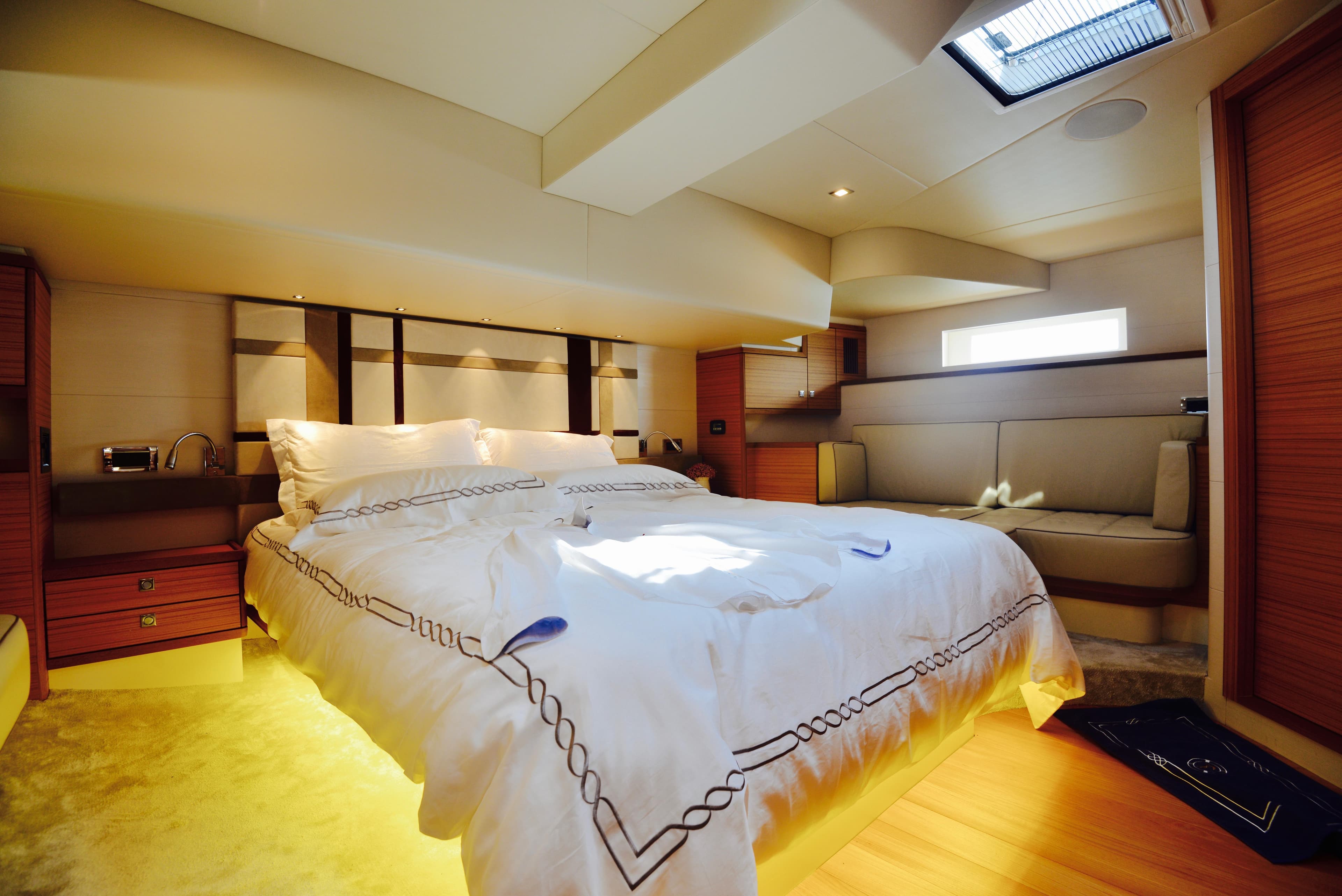 Luxurious bedroom interior of 2017 Mazarin 72 Cruiser/Racer yacht with elegant bedding and ambient lighting.