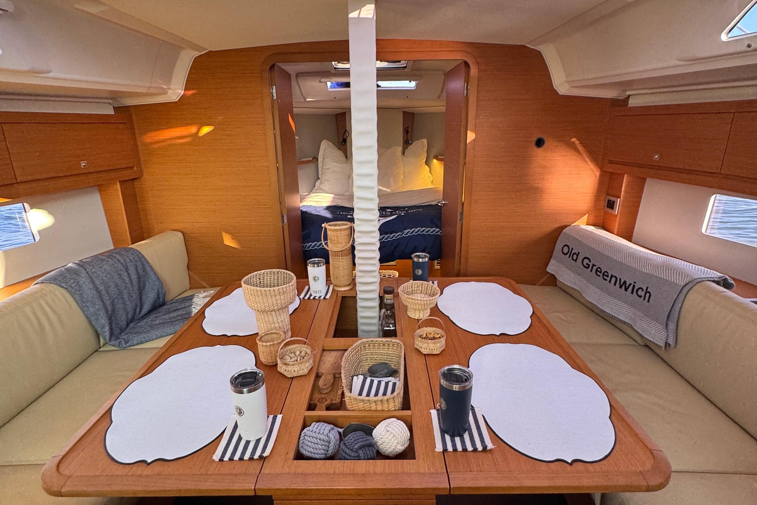 Interior of 2023 Dufour 37 yacht with cozy dining area and elegant decor.
