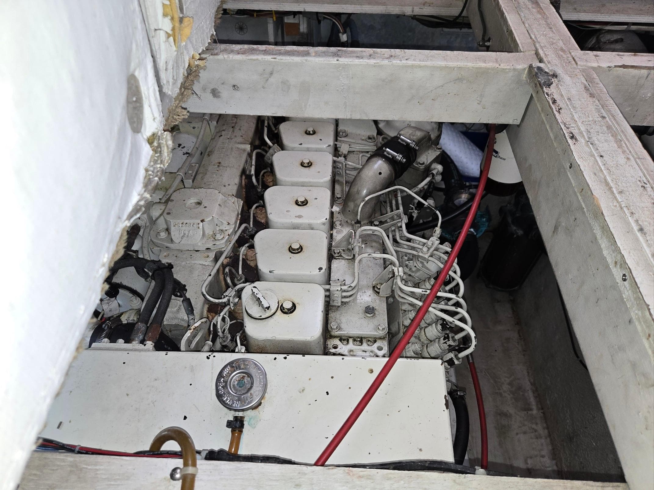 Engine compartment of a 1997 Bayliner 4087 Aft Cabin Motoryacht, showing mechanical components.