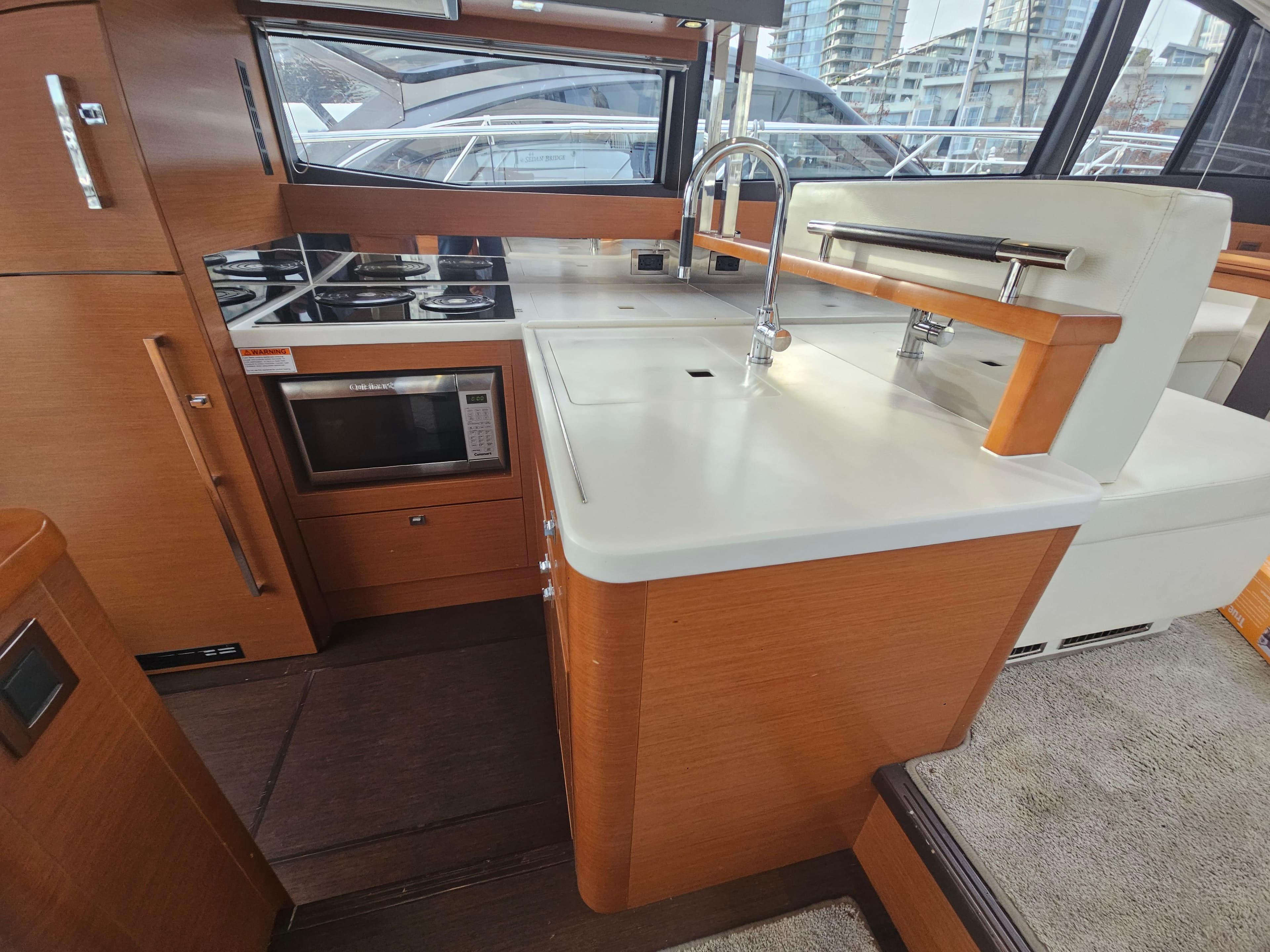 Modern kitchen in 2016 Prestige 500 S yacht with sleek countertops and appliances.