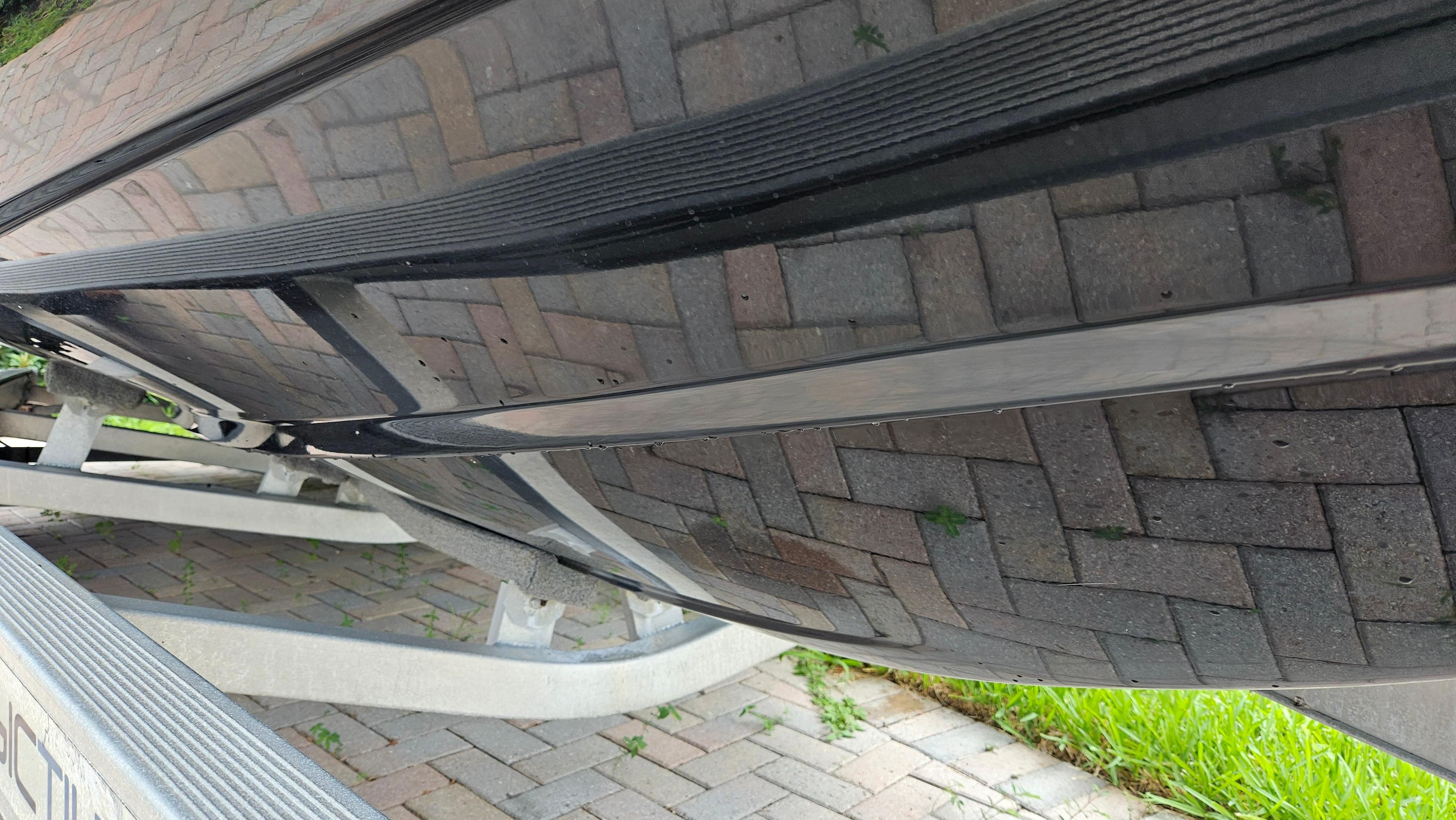 Bottom view of a 2021 Scout 231 XS boat on a trailer.