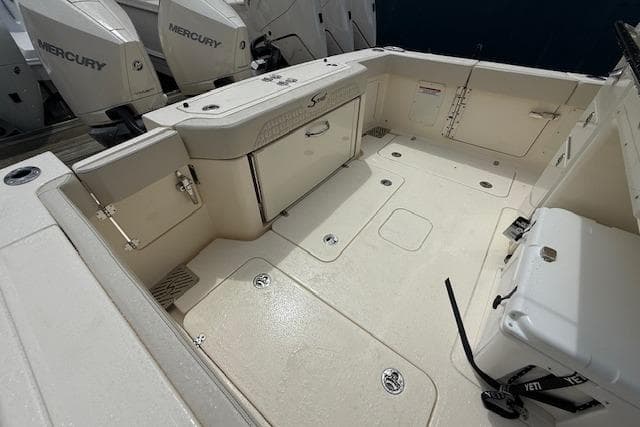 2026 Scout 288 LXF boat deck with Mercury engines, featuring spacious layout and storage compartments.