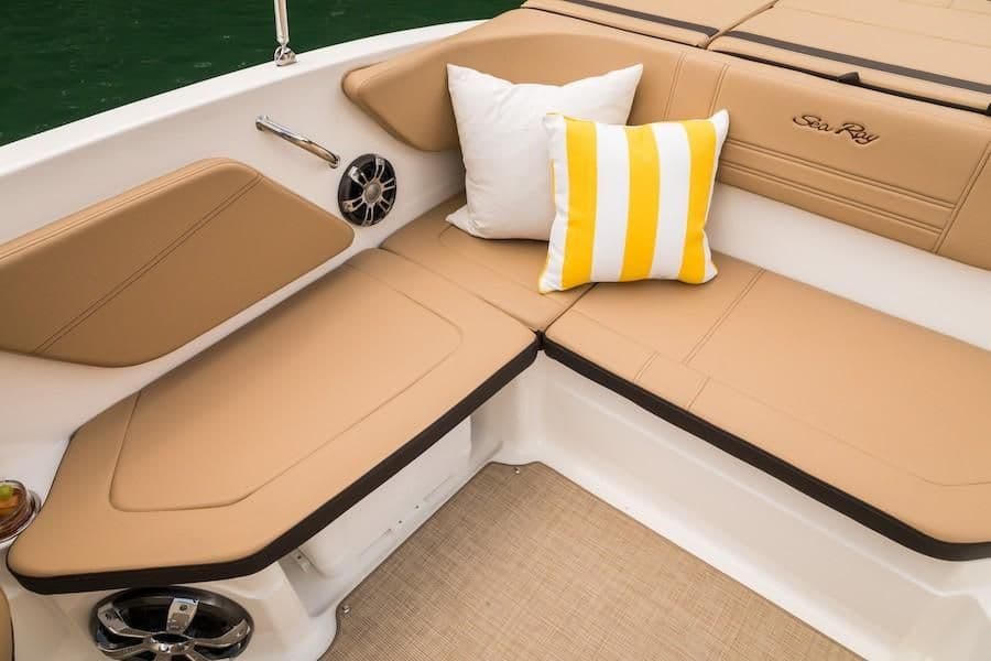 2019 Sea Ray SPX 210 OB boat interior with tan seating and decorative pillows.