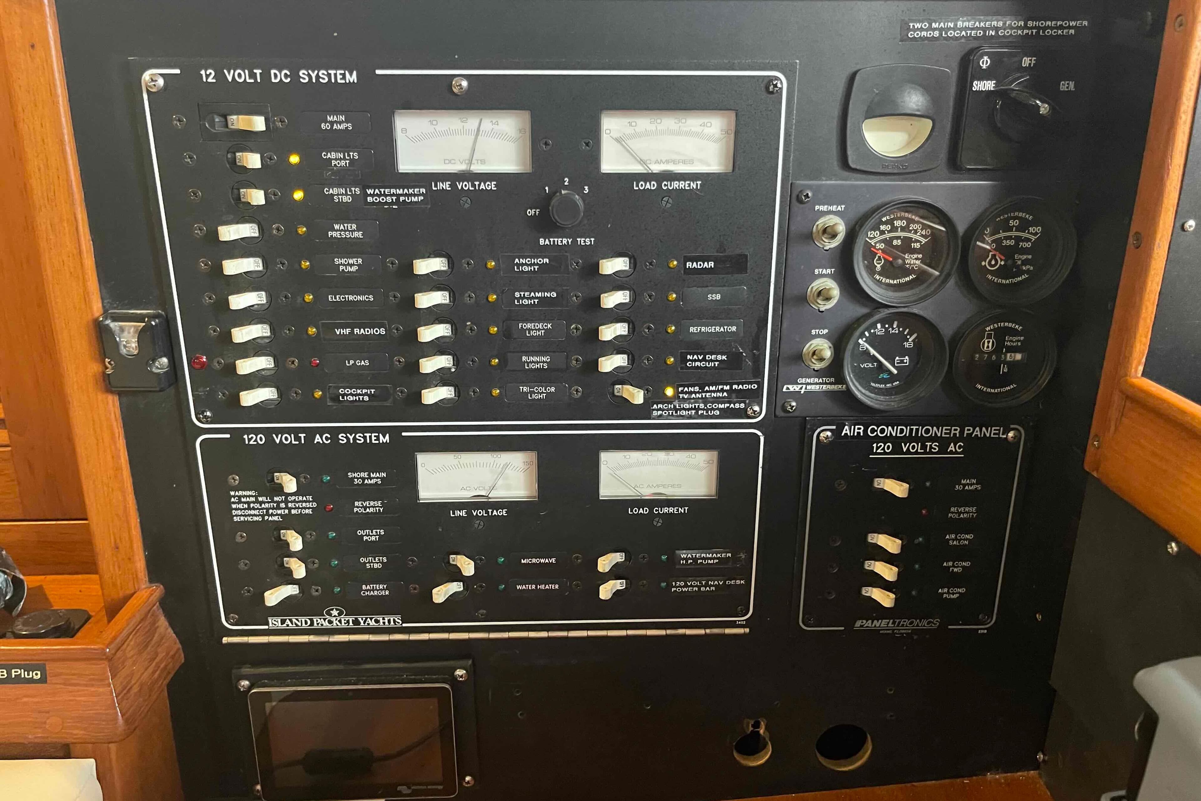 Electrical control panel on a 1998 Island Packet 40 yacht, featuring gauges and switches.
