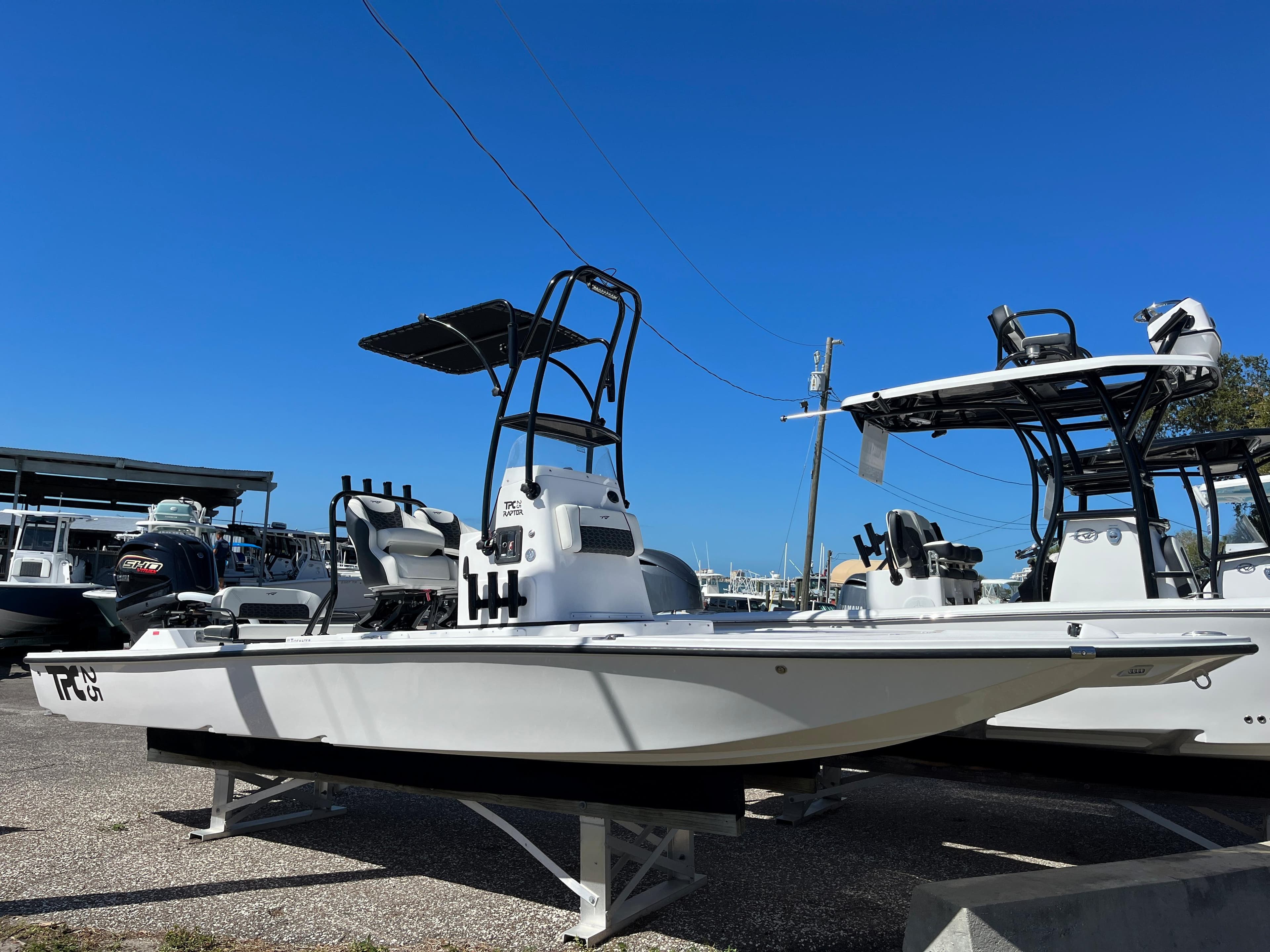 2025 Tidewater 25 TPC boat on display under clear blue sky.