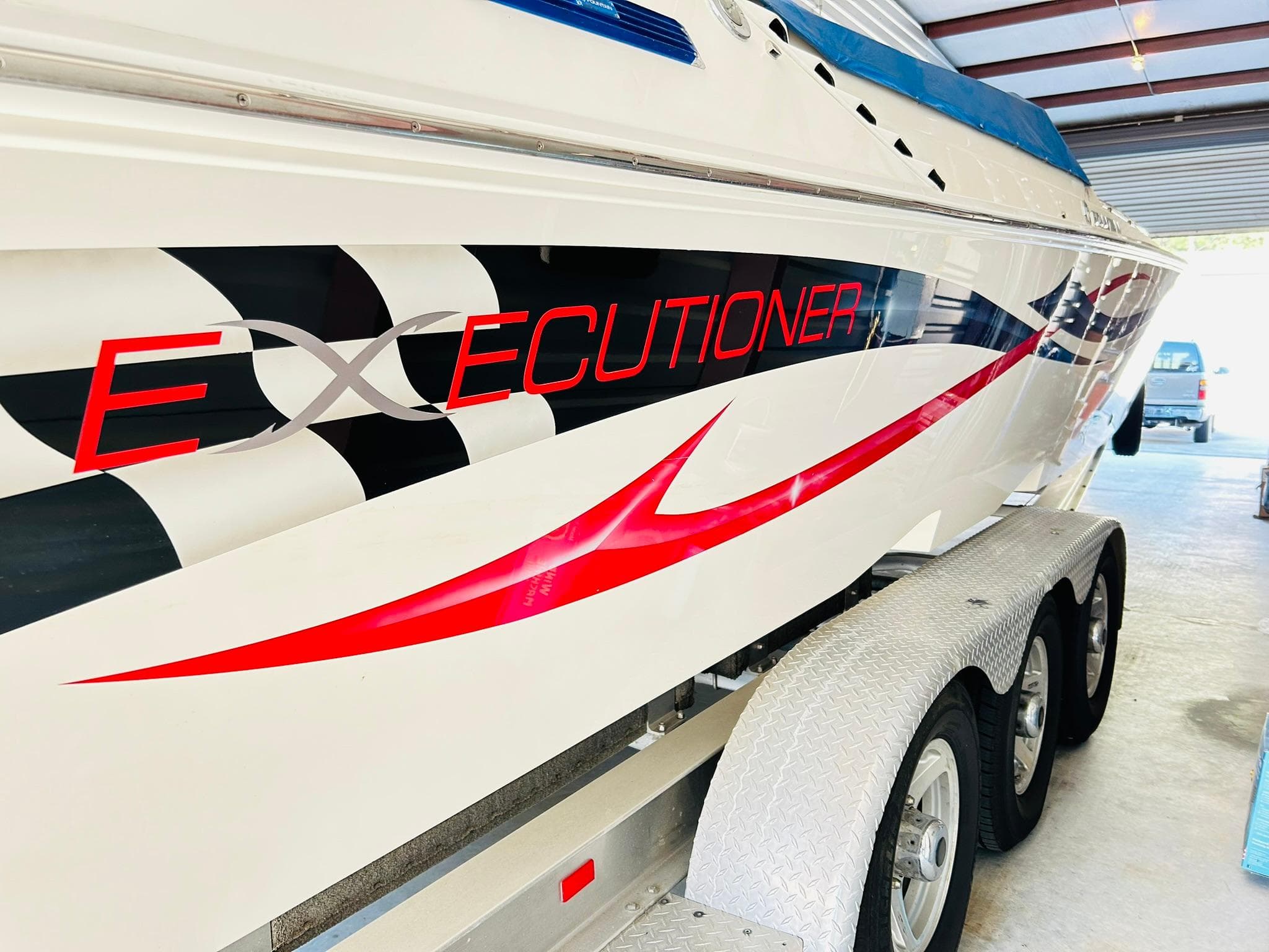 2005 Fountain 42 Executioner speedboat with bold graphics on a trailer.