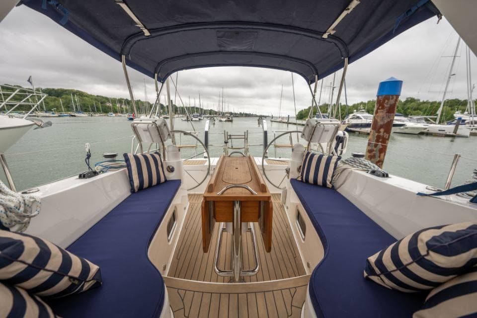 Luxurious 2019 Southerly 480 yacht cockpit with blue cushions and striped pillows.