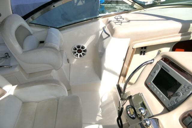 2005 Sea Ray 340 Sundancer cockpit with steering, controls, and seating.