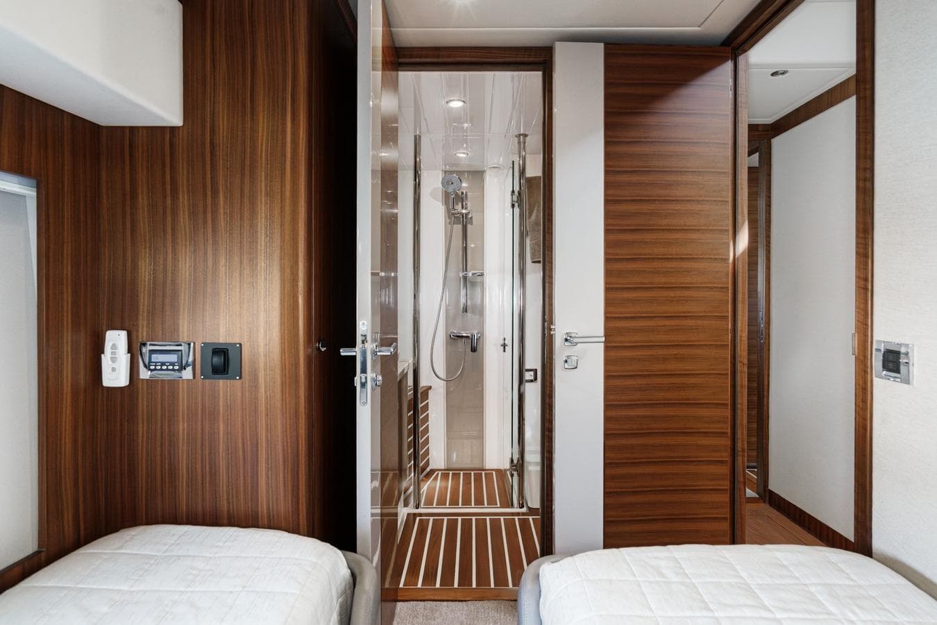 Luxurious interior of 2019 Belize 66 Sedan yacht with wood paneling and modern bathroom.