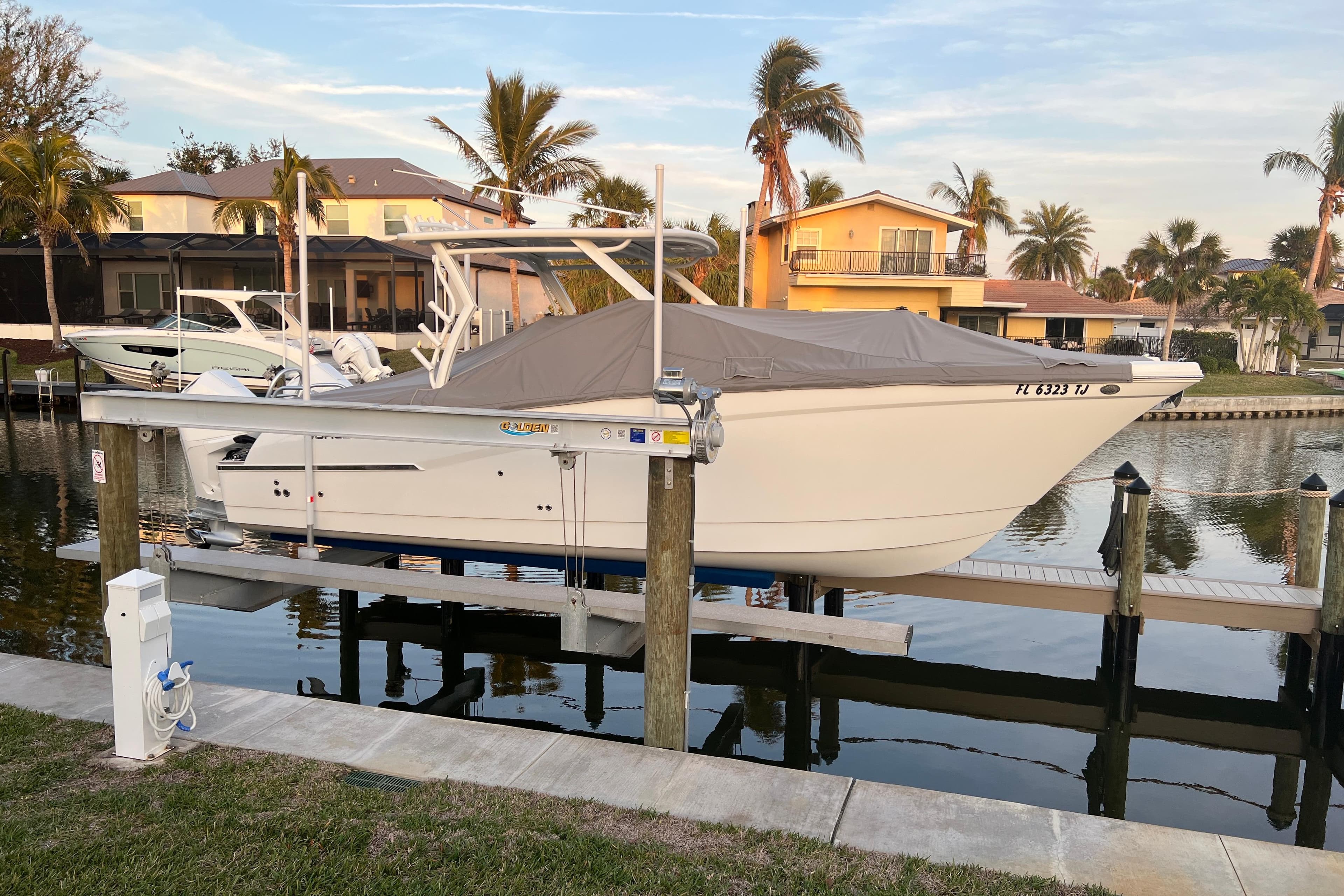 2023 World Cat 280 DC-X boat docked in a scenic waterfront setting.