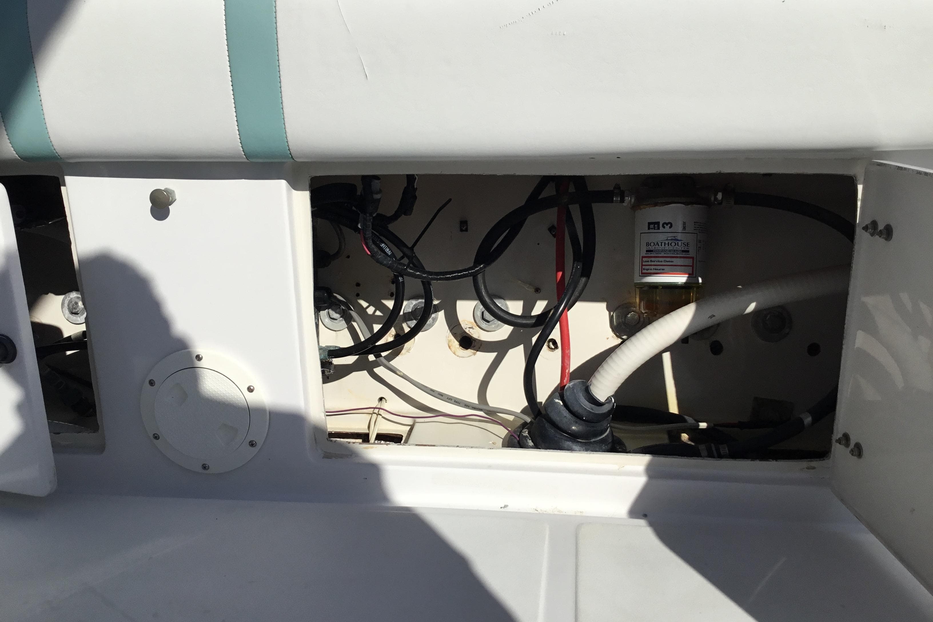 Open compartment of a 2000 Jupiter 31 Center Console boat showing wiring and components.